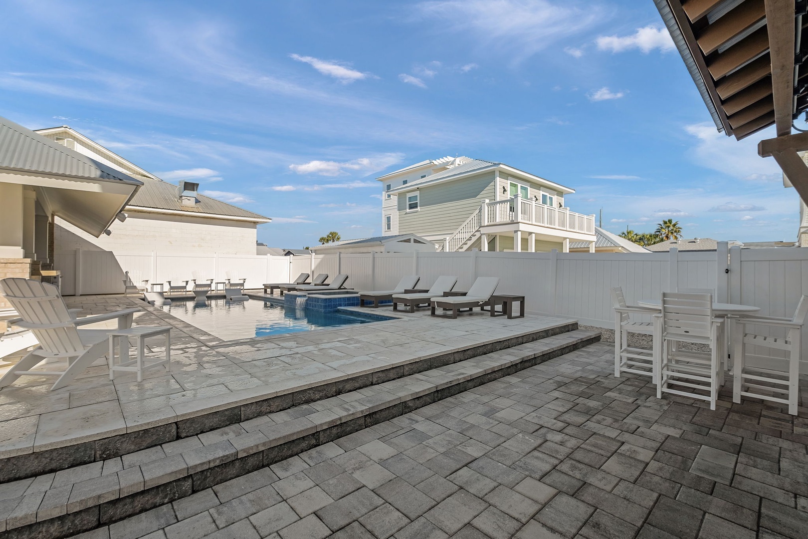 Step into your private poolside paradise where lounge chairs await sun-soaked afternoons and the sparkling blue water beckons for refreshing dips.