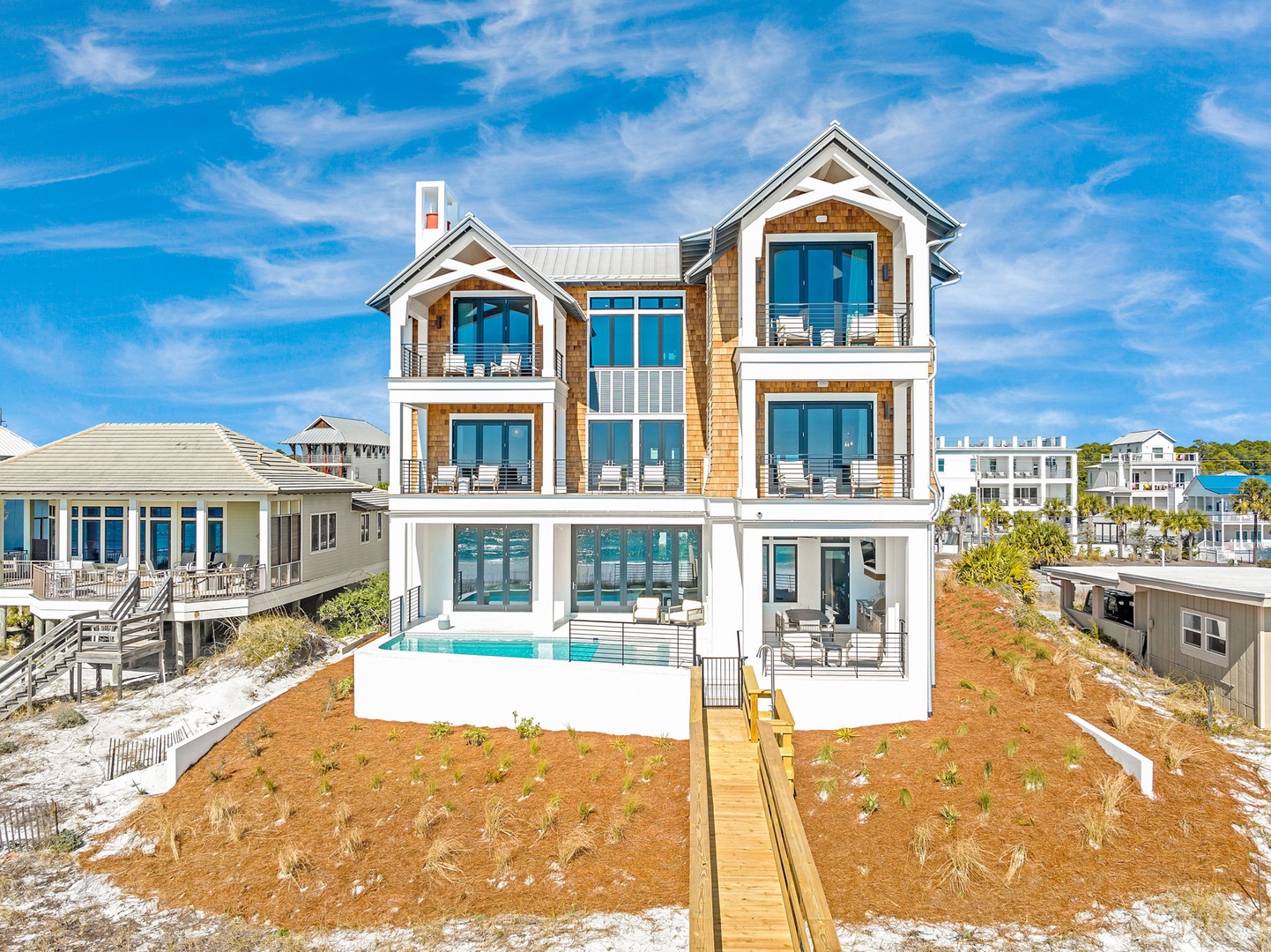 Stunning beachfront property with private pool and multiple balconies overlooking pristine coastal views.