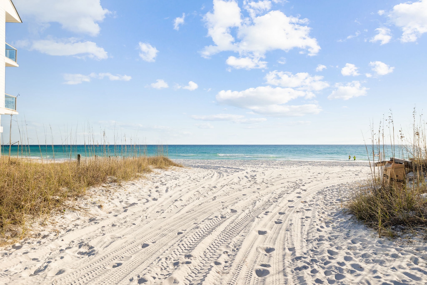 Pristine white sand beach with crystal-clear turquoise waters stretches endlessly along the coastline near the property.