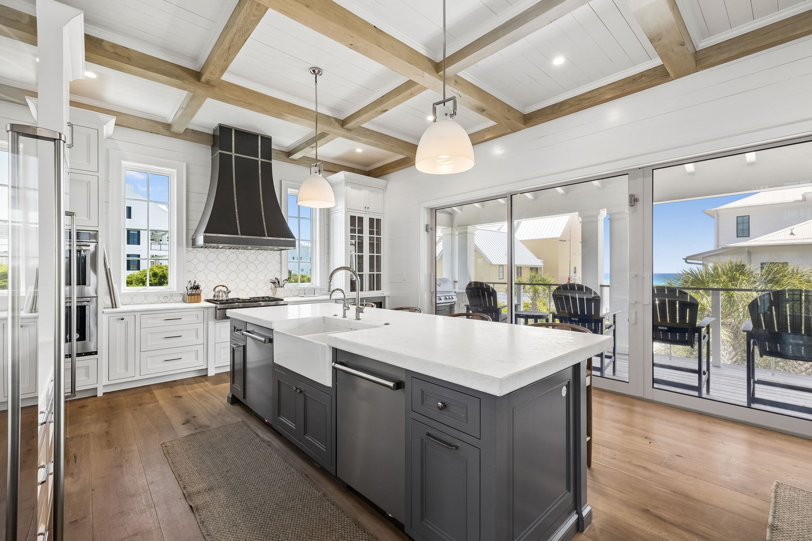Step into your gourmet kitchen where rustic beams meet modern elegance. Prepare meals at the spacious island, then glide open the glass doors to your private deck for dining with a view.