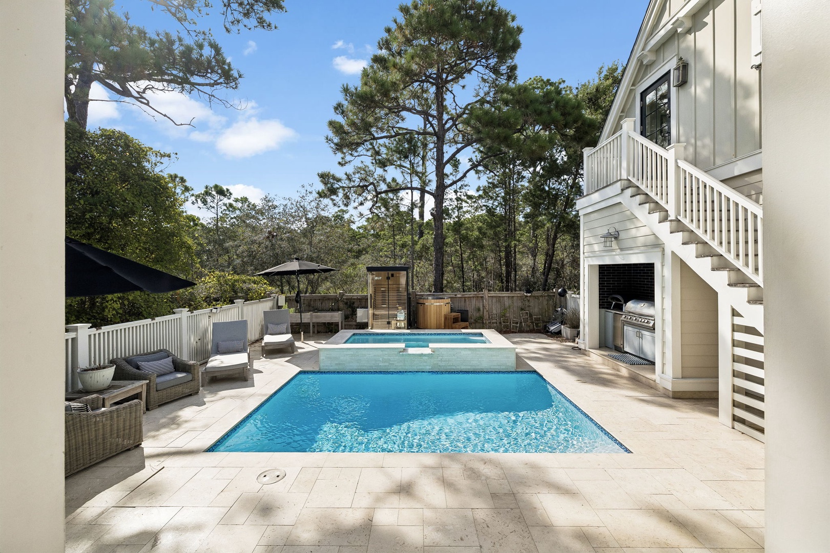 A private resort-style backyard where sunny afternoons stretch endlessly—your pool beckons with cool blue water, a hot tub invites starlit soaks, and a sauna waits to melt every worry away.