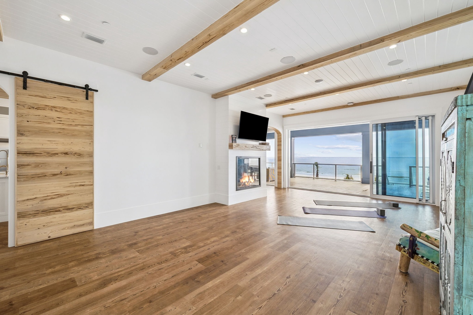Breathe in the ocean air as you step into your bright, modern living space with soaring beam ceilings and stunning sea views stretching beyond.