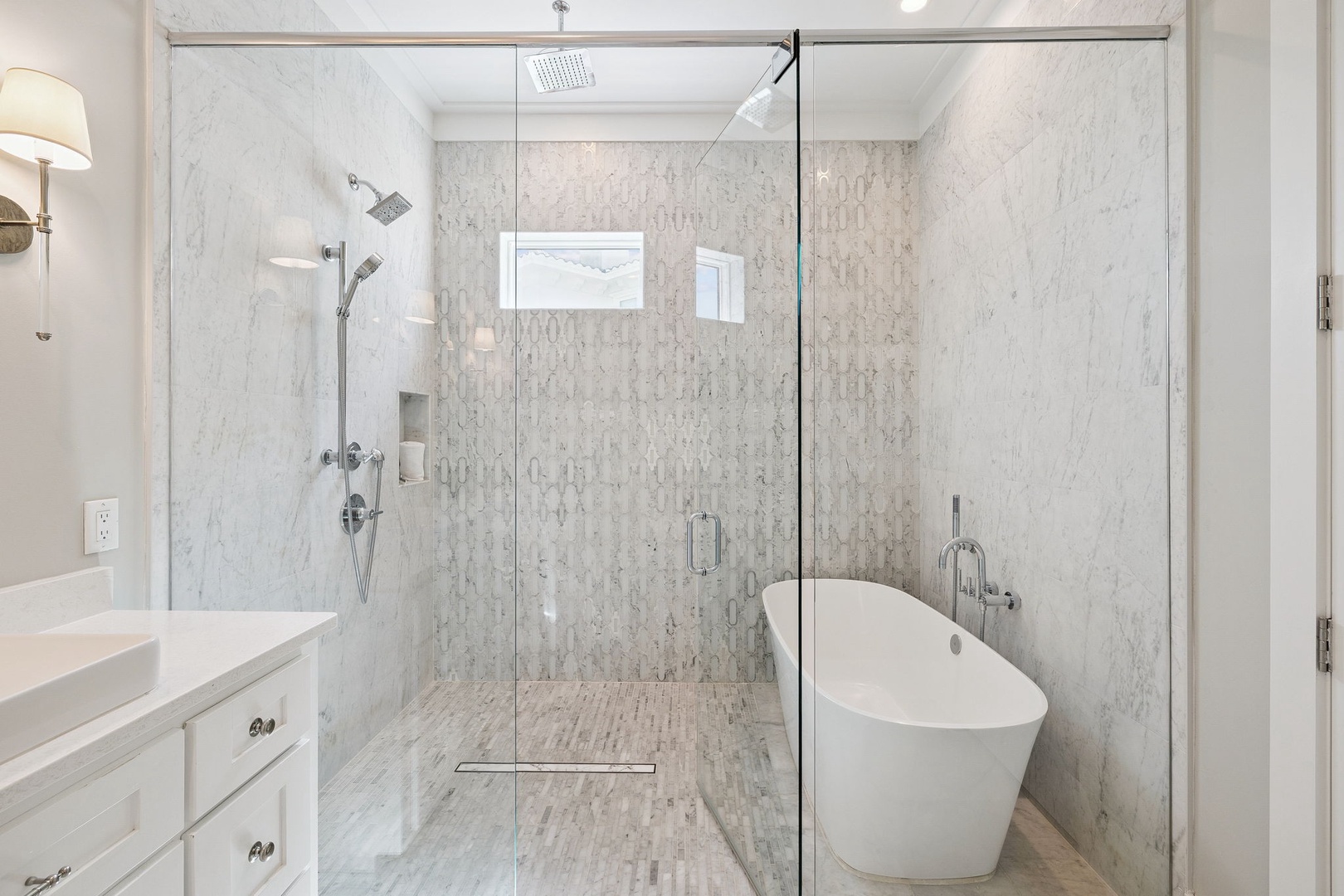 Step into your luxurious marble bathroom featuring a rainfall shower and elegant soaking tub for ultimate relaxation.