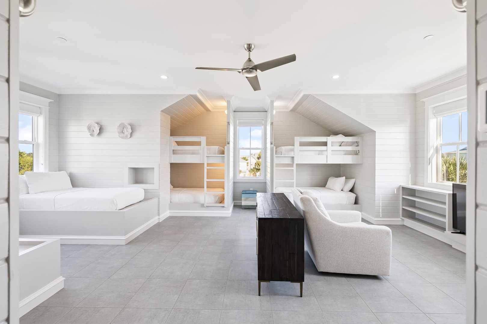 Your kids will love this whimsical bunk room with house-shaped built-ins and plenty of space to play and relax together.