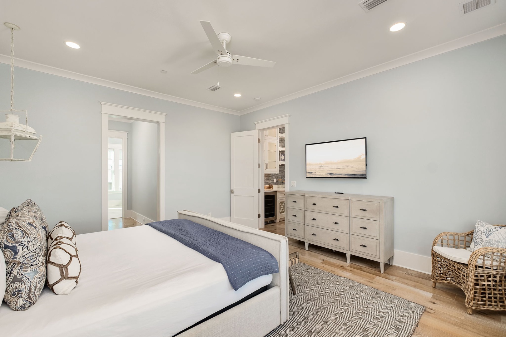 Unwind in this serene bedroom featuring crisp linens, coastal decor, and your private TV for relaxing evenings.