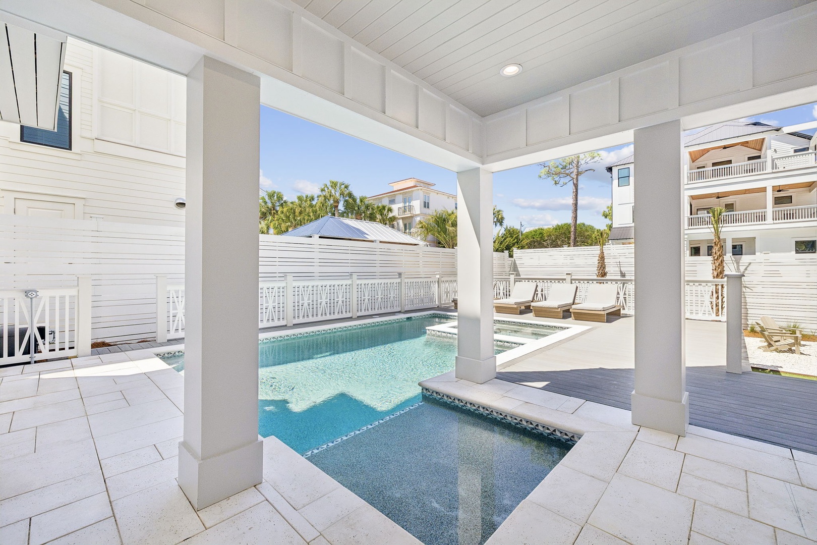 Step into your private poolside oasis where crystal-clear waters and elegant covered lounging await your perfect beach getaway.