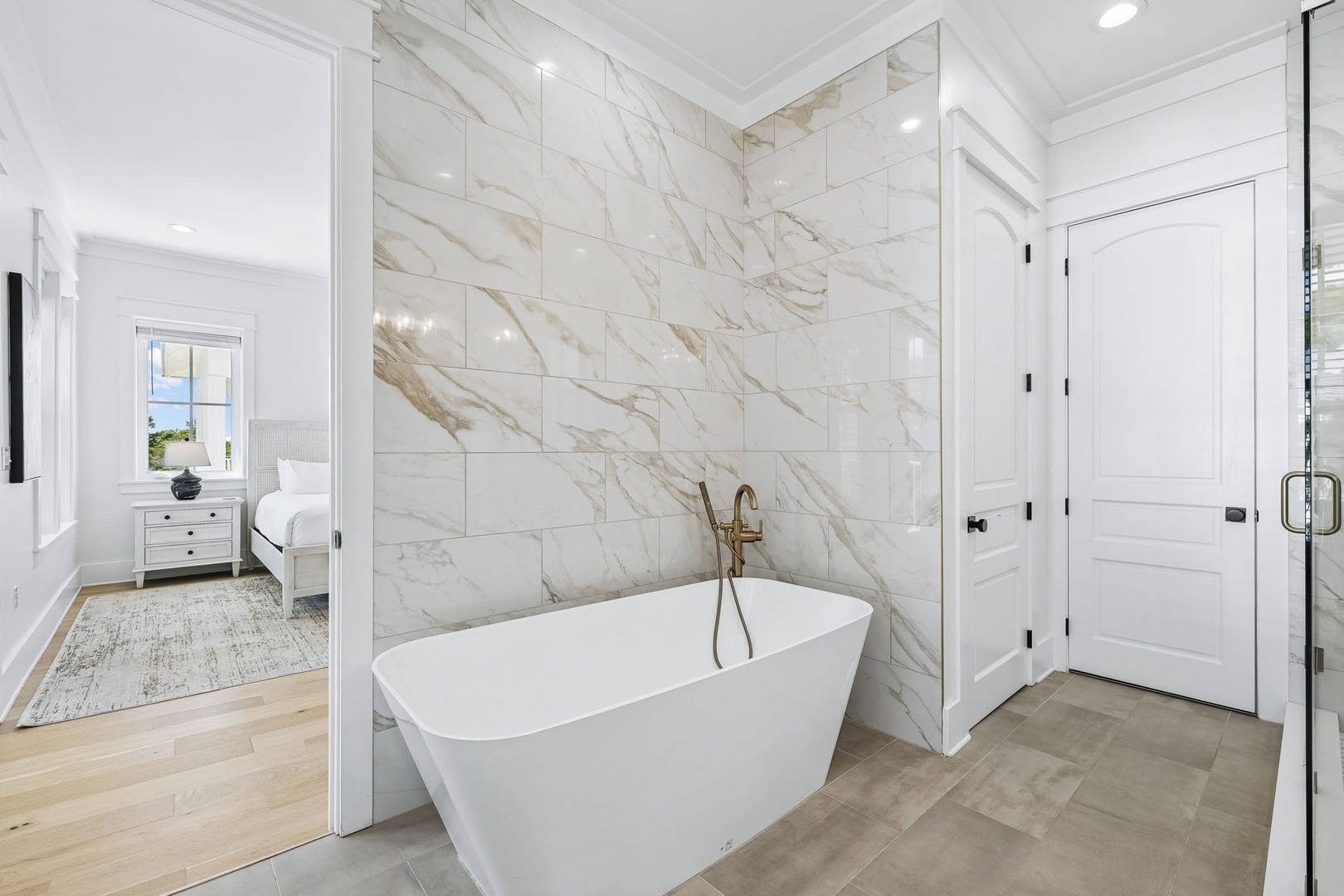 Slip into your luxurious soaking tub and let the day melt away against stunning marble walls. This spa-like retreat offers the perfect place to unwind and recharge.