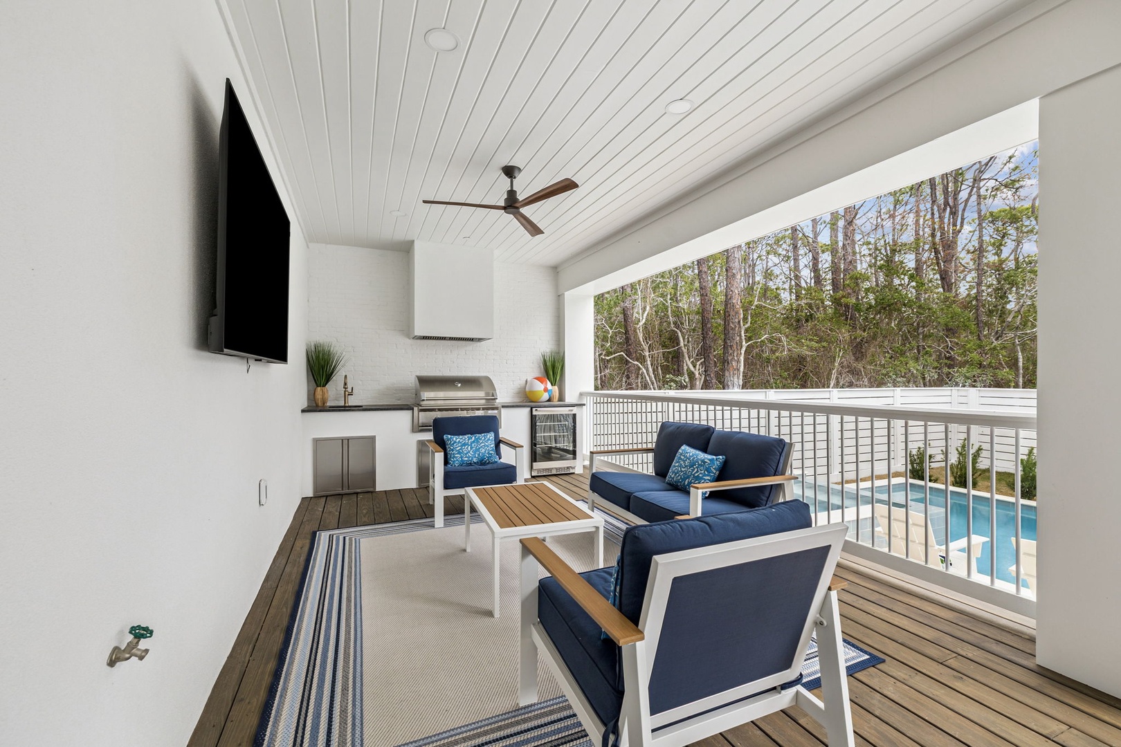 Relax in your covered terrace with pool views, outdoor kitchen, and ceiling fan for perfect entertaining.