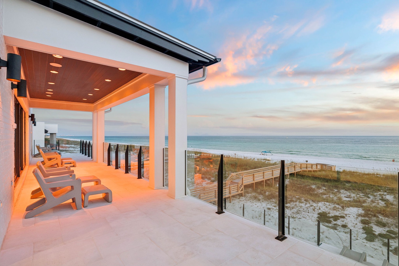 Beachfront covered terrace with direct access to white sand shores and sweeping ocean views—your private retreat for morning coffee or evening sunsets.