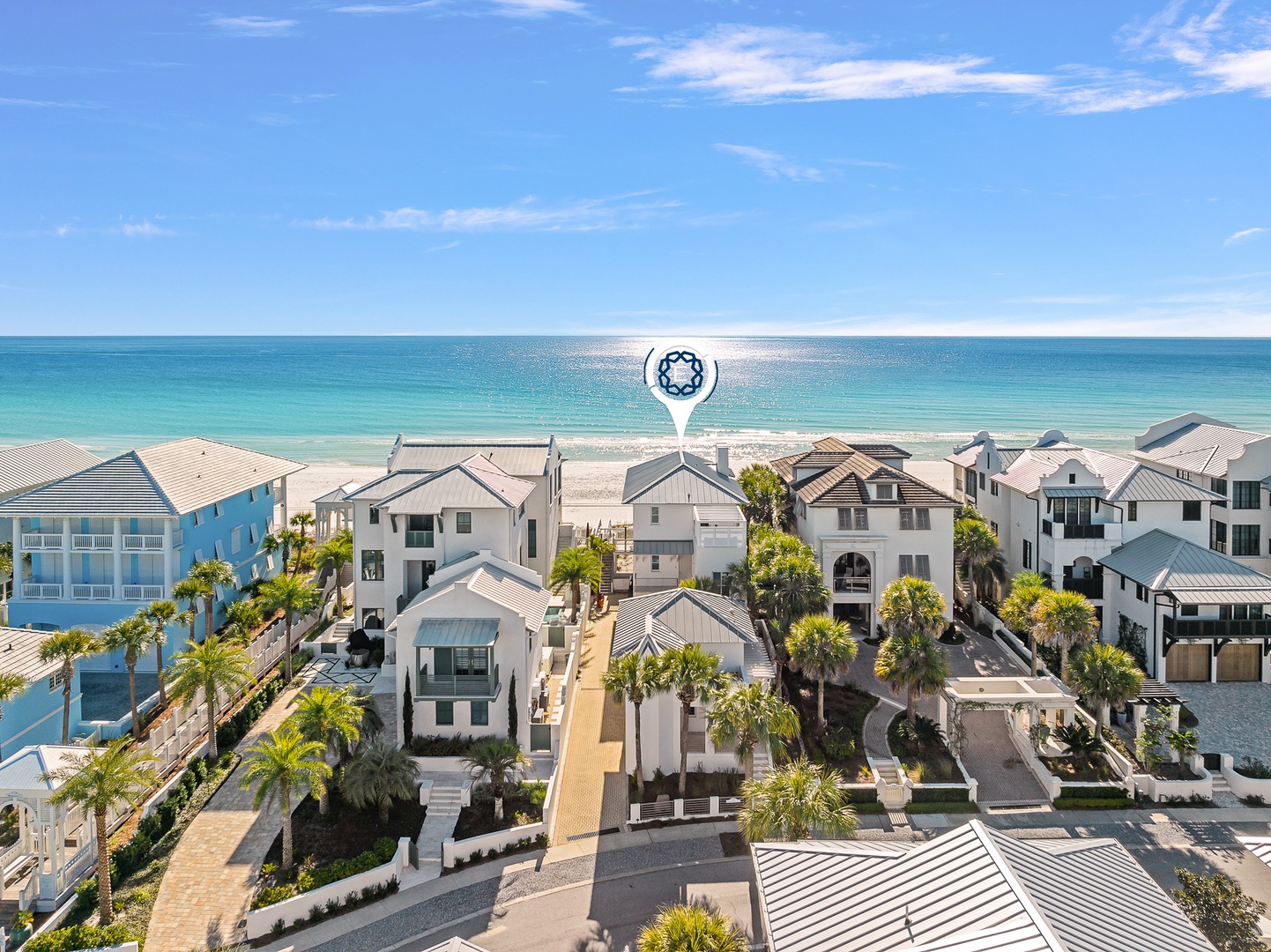 Stunning beachfront community with pristine white sand beach and turquoise waters just steps away from charming coastal homes.