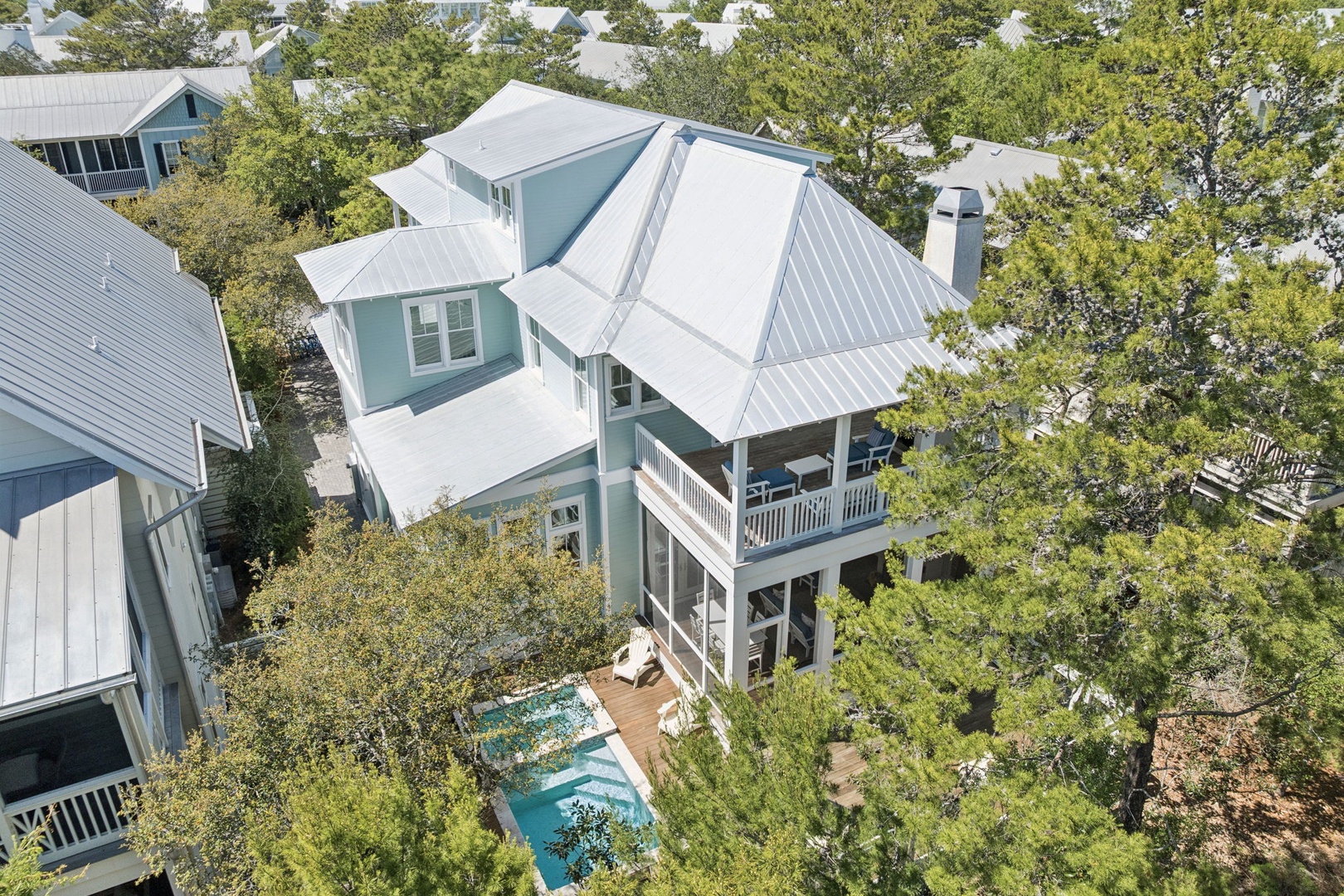 Stunning coastal retreat with private pool nestled among mature trees in peaceful neighborhood.