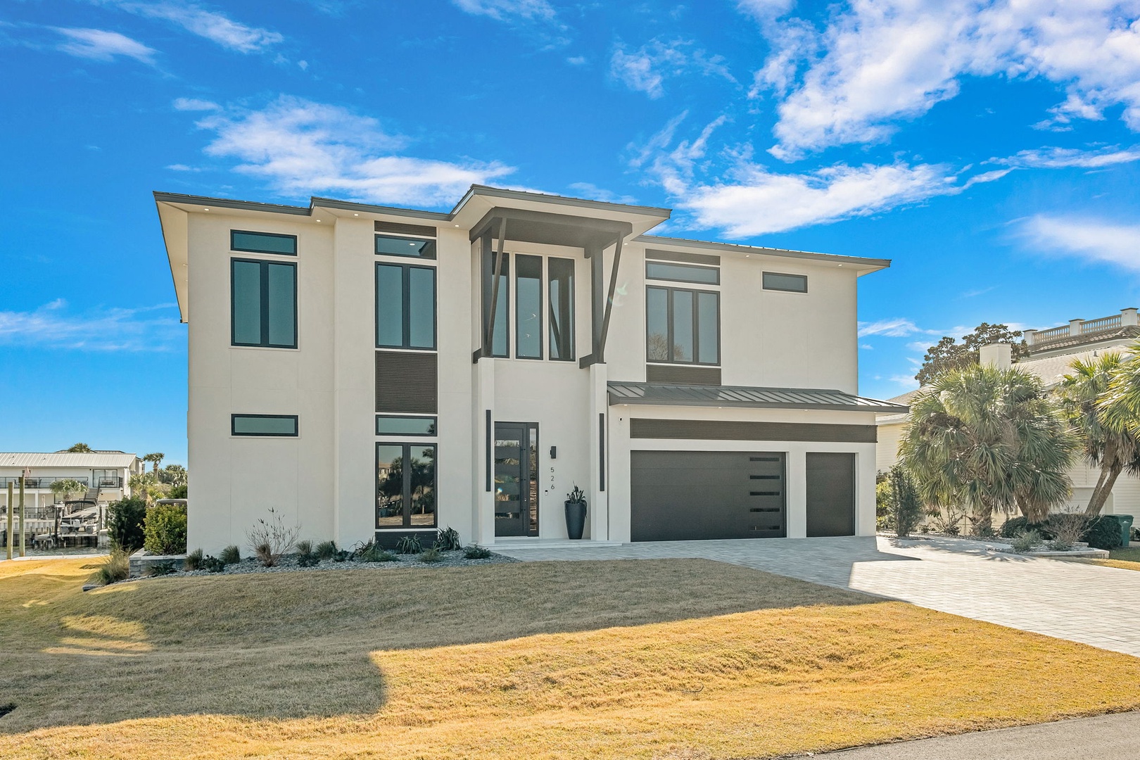 Modern two-story home with contemporary architecture featuring clean lines and abundant natural lighting in a peaceful residential setting.