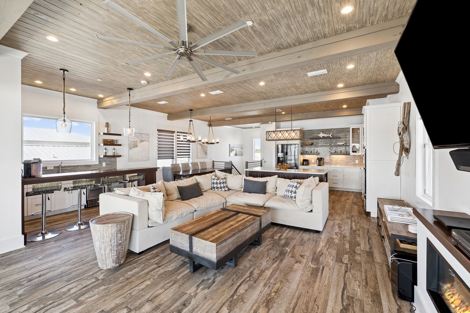 Unwind in this stunning open-concept space where soaring wood ceilings and cozy furnishings create your perfect retreat sanctuary.