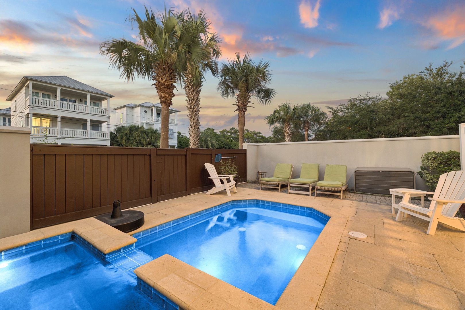 Step into your private courtyard where a sparkling pool awaits under swaying palms and soft sunset hues—your perfect escape for warm evenings and lazy afternoons.