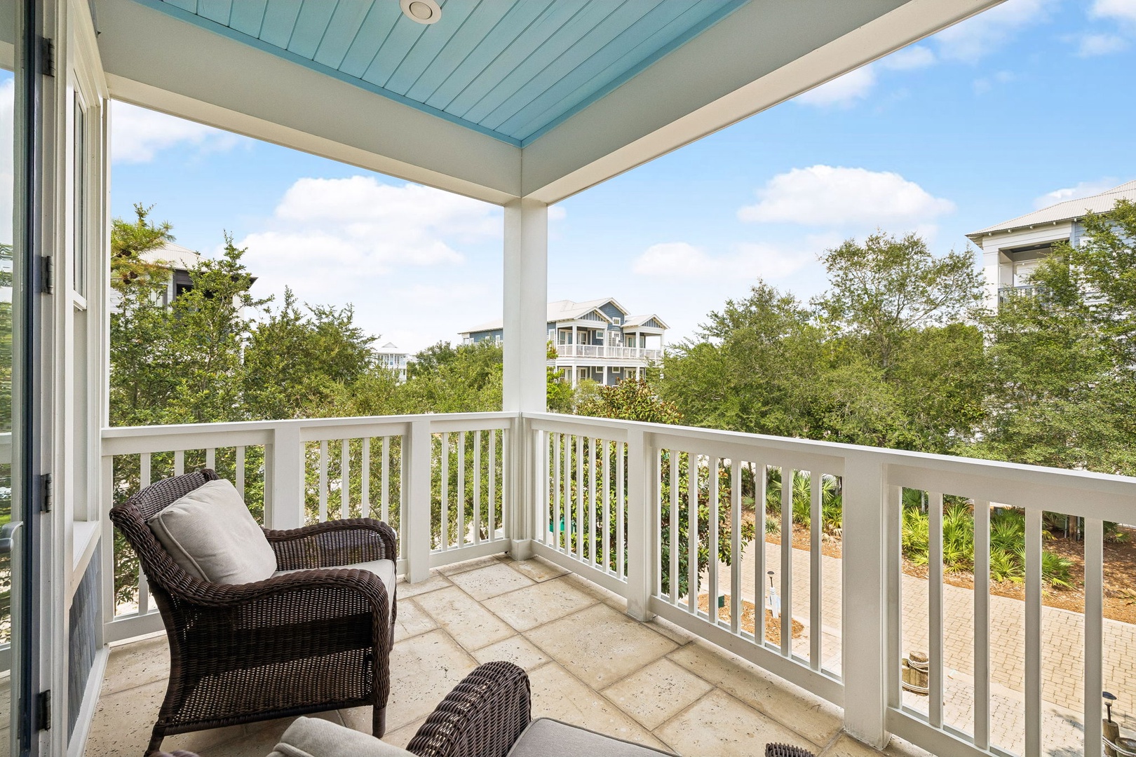 Settle into your private balcony with morning coffee, taking in the lush treetop views and gentle coastal breeze—your peaceful spot to unwind after a day exploring.