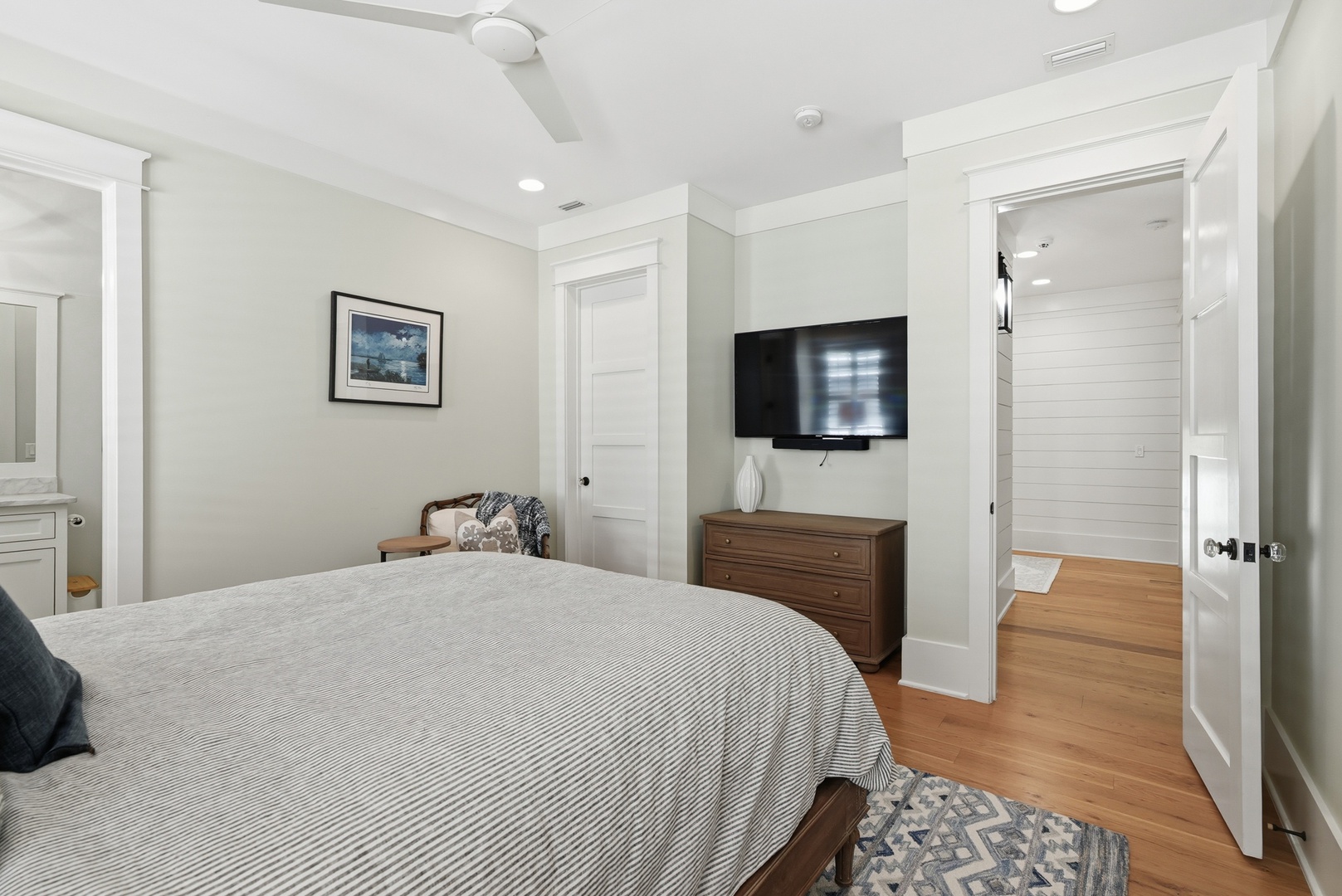 Unwind in your peaceful bedroom with a comfy bed, flat-screen TV, and warm wood floors. You'll love the ensuite bath and ceiling fan for those warm evenings.