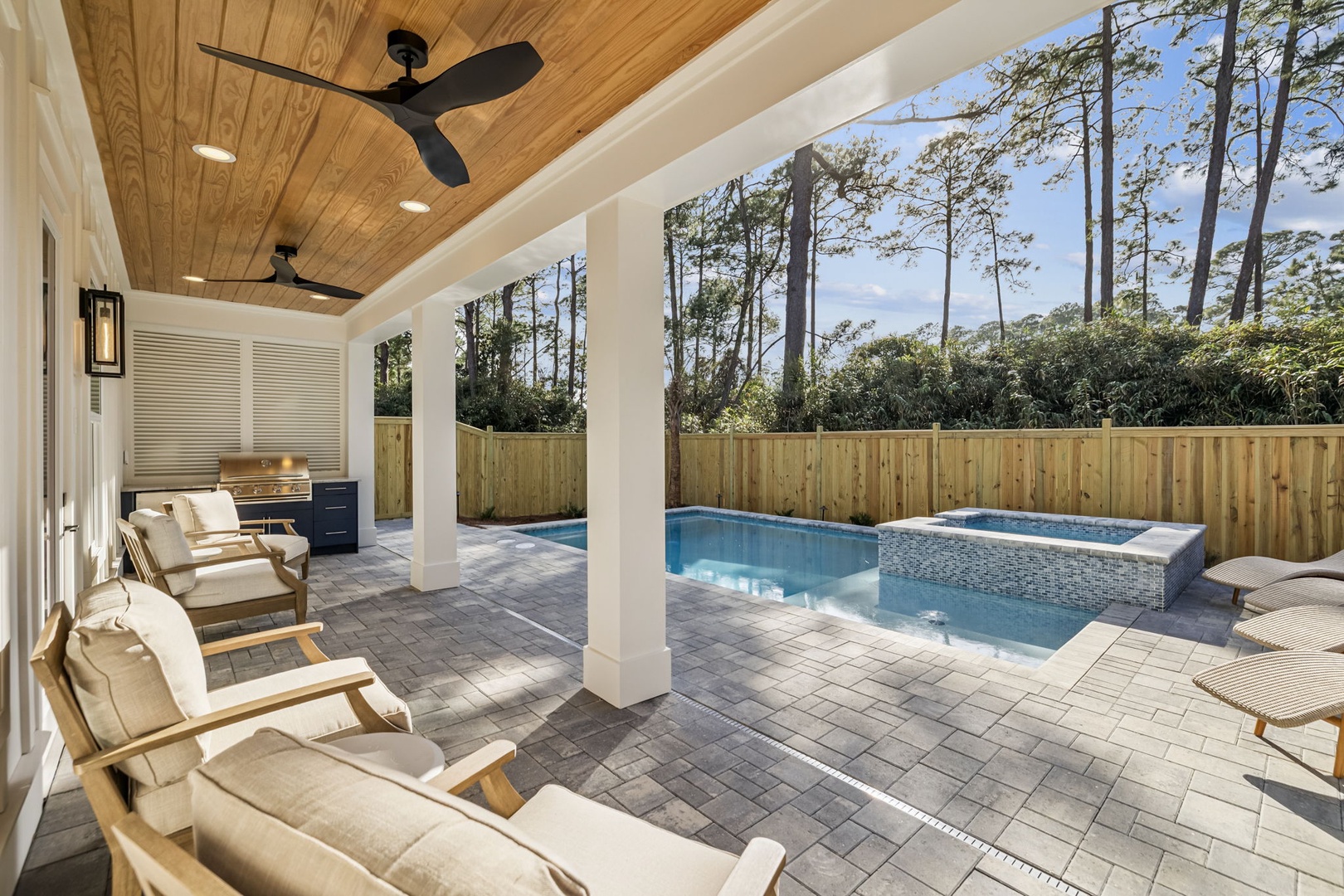 Your private poolside retreat awaits with comfortable loungers and an outdoor kitchen, perfect for relaxing afternoons.