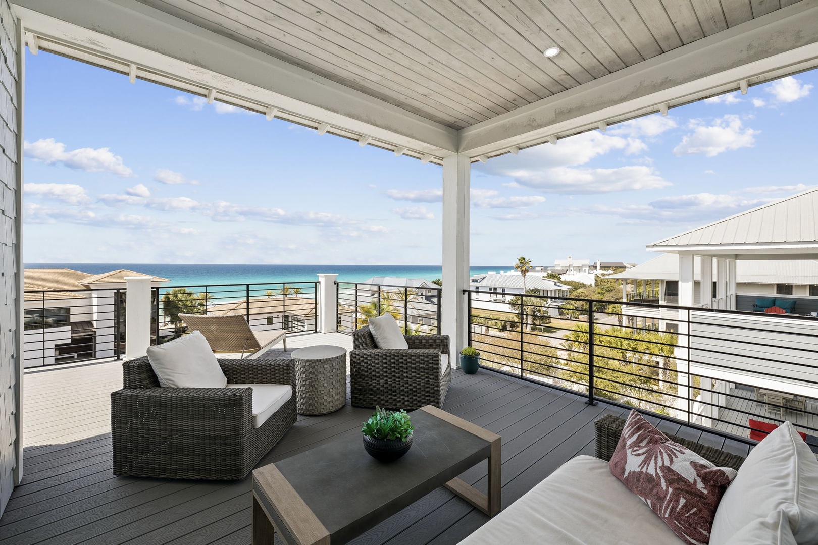 Relax on your private terrace with stunning ocean views, where comfortable seating invites you to unwind while taking in the endless blue horizon.