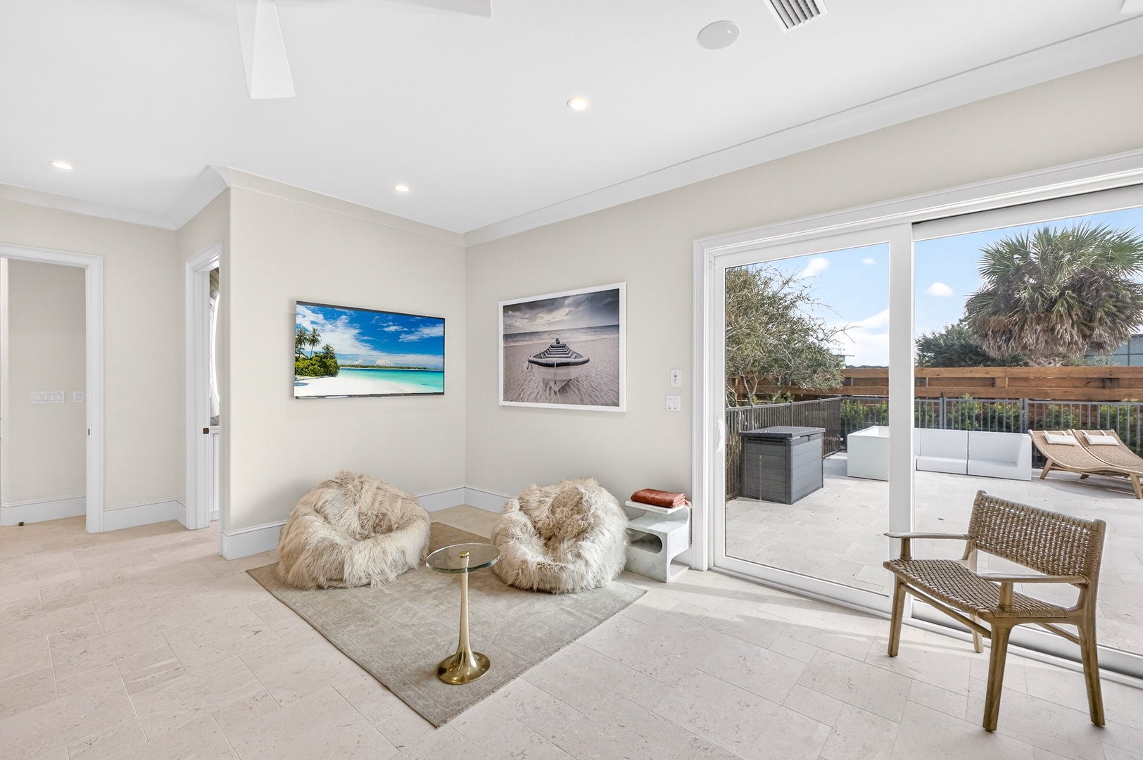 Sink into plush fur bean bags in your bright, airy living space that flows seamlessly to your private terrace.