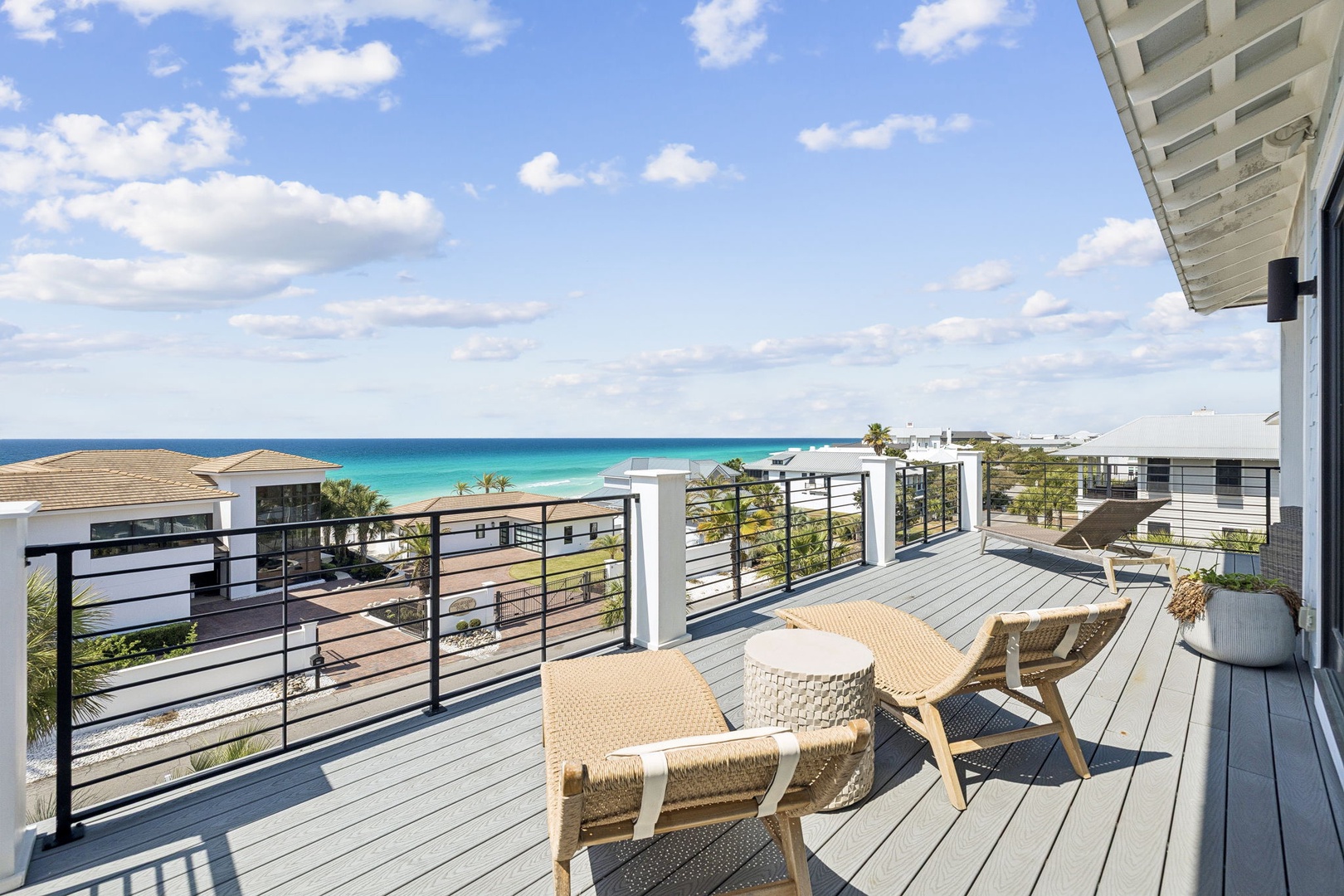 Soak in stunning turquoise waters from your private deck, where woven chairs invite relaxation against endless ocean views.