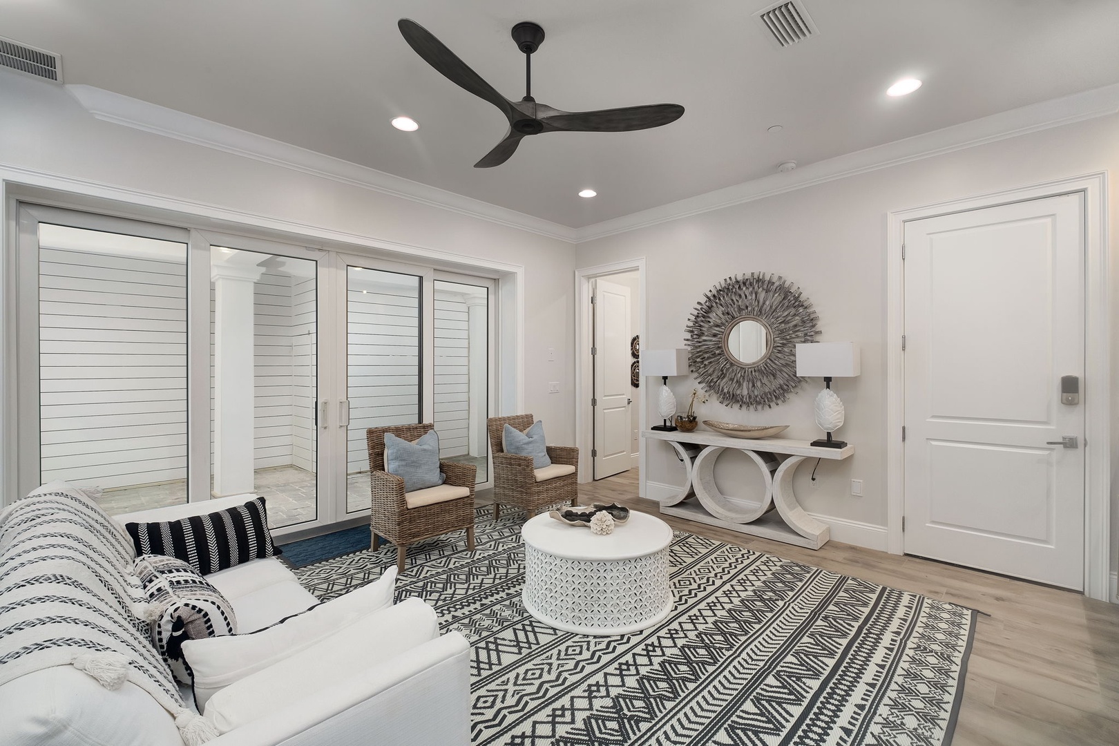 Unwind in your stylish living room where coastal elegance meets comfort—plush seating, artistic touches, and breezy ambiance create your perfect retreat.