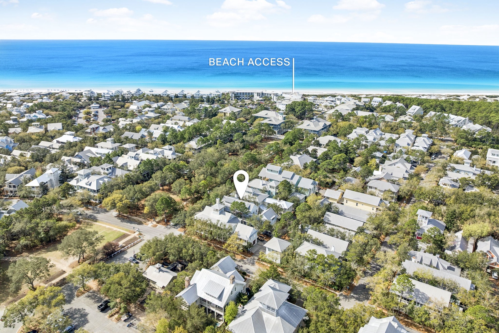 Aerial view showcasing the property's prime location within a tree-lined coastal community, with convenient beach access nearby.