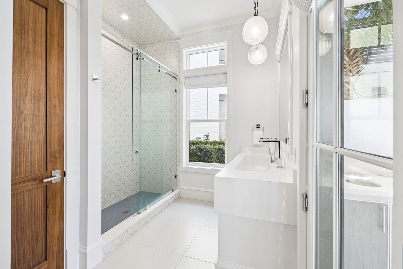Luxurious bathroom with marble finishes, glass shower, and soaking tub creates your private spa retreat.
