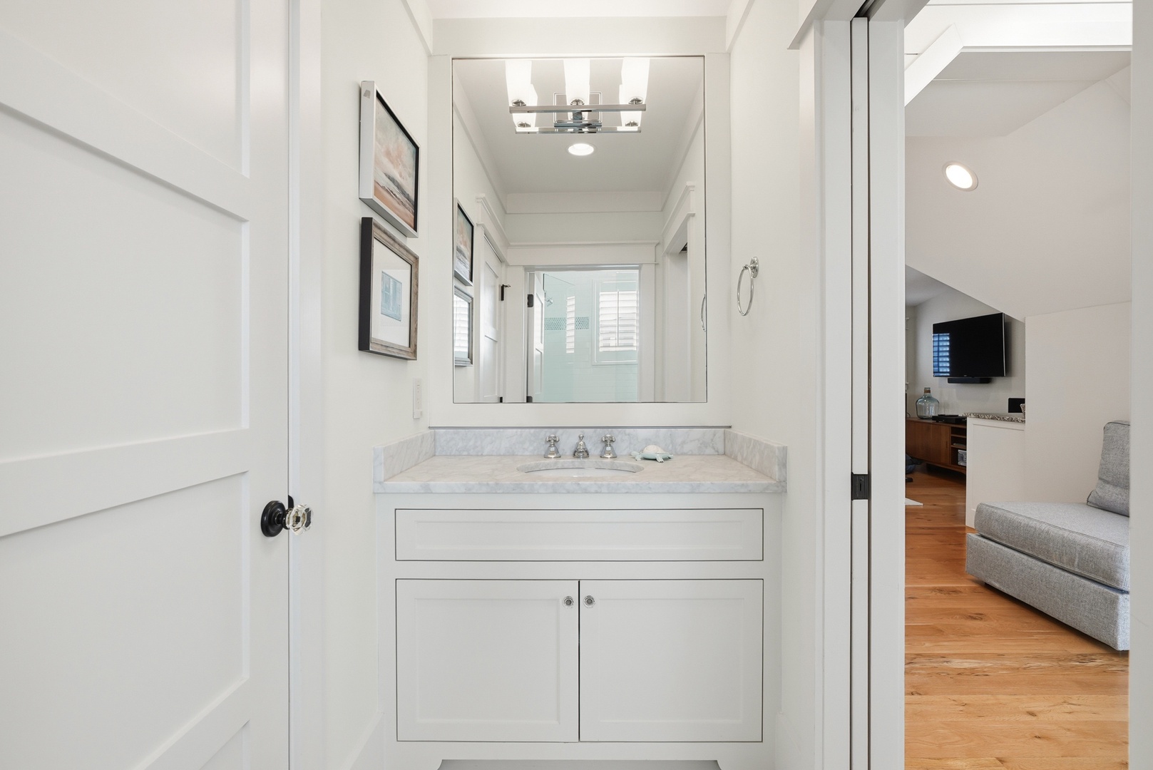 Step into your bright, beautifully designed bathroom featuring a marble-topped vanity, elegant mirror, and modern fixtures that make freshening up feel like a spa experience.