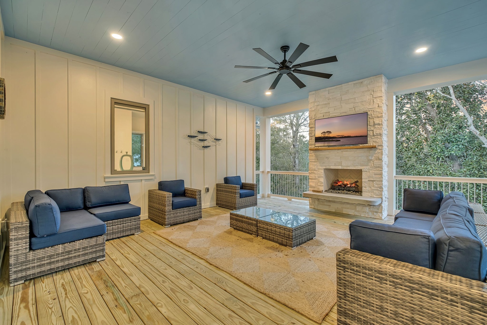 Relax in your private covered porch with cozy seating, crackling fireplace, and peaceful forest views for the perfect retreat.