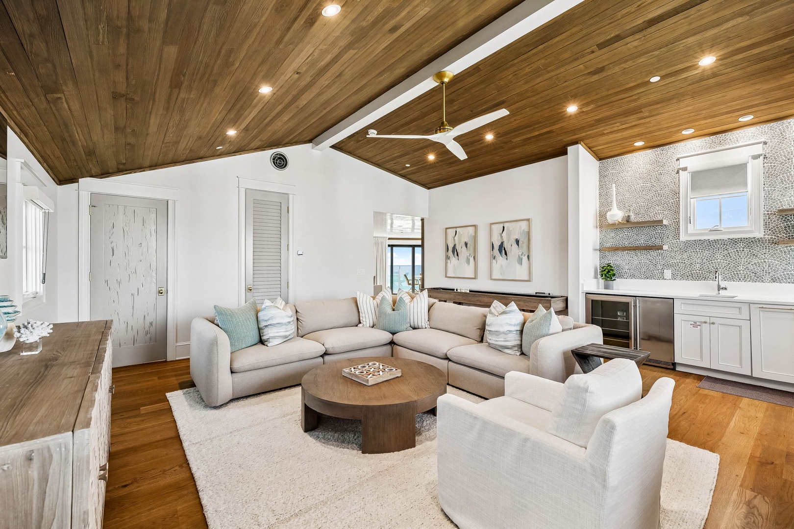 Sink into plush seating beneath soaring wood ceilings in your bright, airy living space. Coastal tones and rich textures create the perfect backdrop for relaxation after exploring nearby beaches.