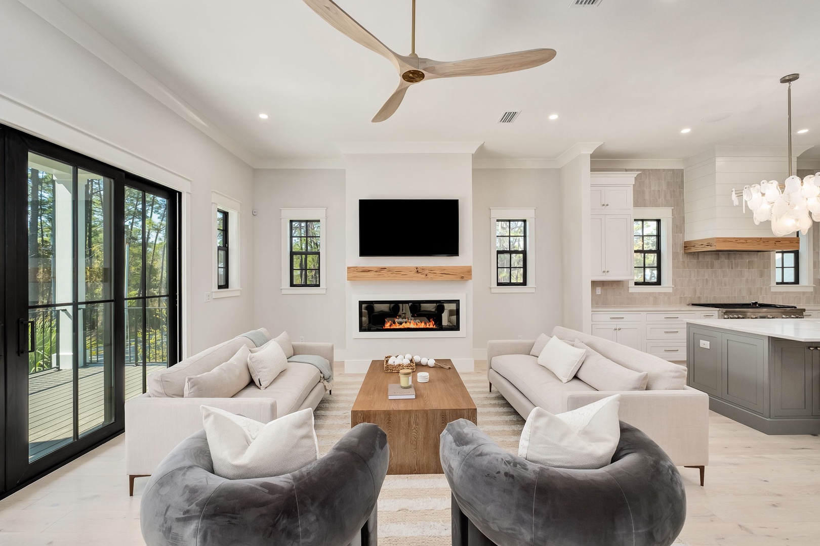 Sink into plush sofas around your warm fireplace, where modern luxury meets comfort in this open-concept retreat.