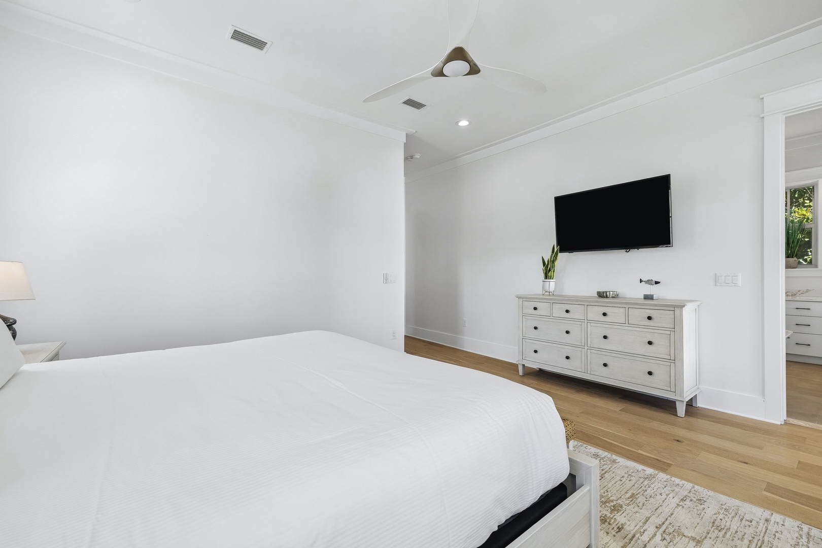 Slip into crisp white linens and let the calm, airy design of your bedroom melt away the day. With warm wood floors underfoot and plenty of natural light, this serene retreat is your peaceful home base.