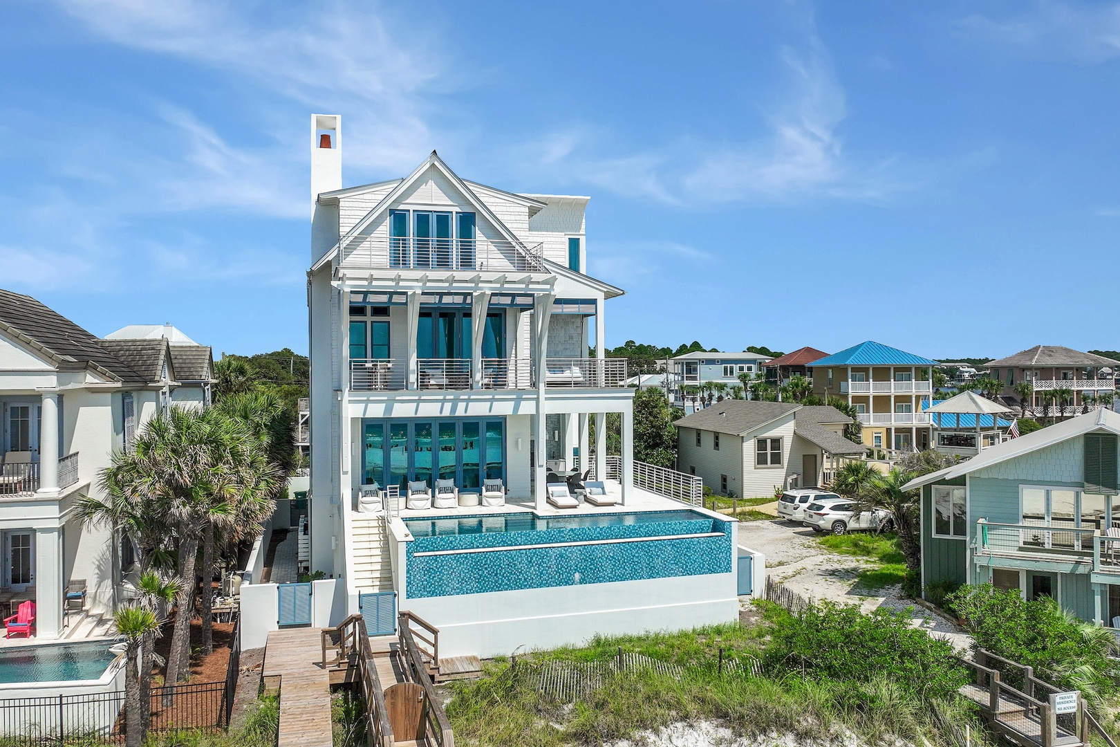 This stunning coastal retreat features expansive multi-level balconies overlooking a private pool in a charming beachside neighborhood, offering the perfect blend of luxury and seaside living.