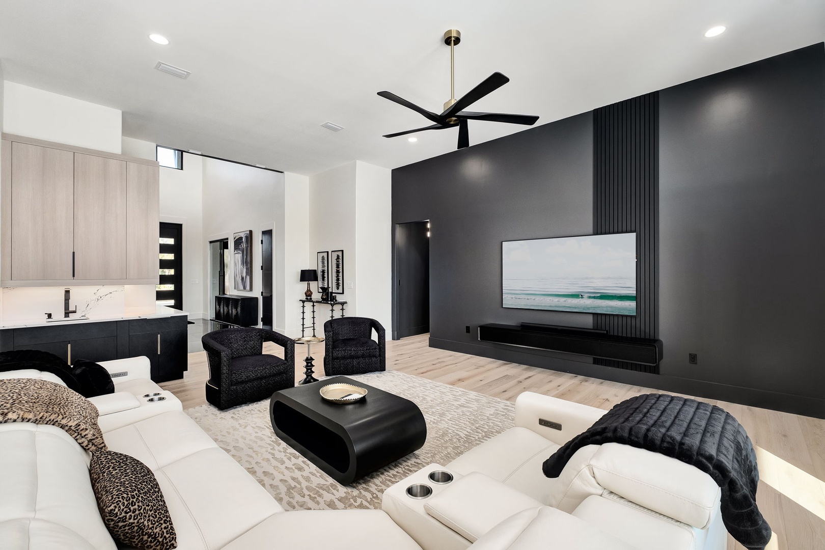 Sink into modern luxury with sleek furnishings, soaring ceilings, and an open-concept design that flows seamlessly from living to kitchen.