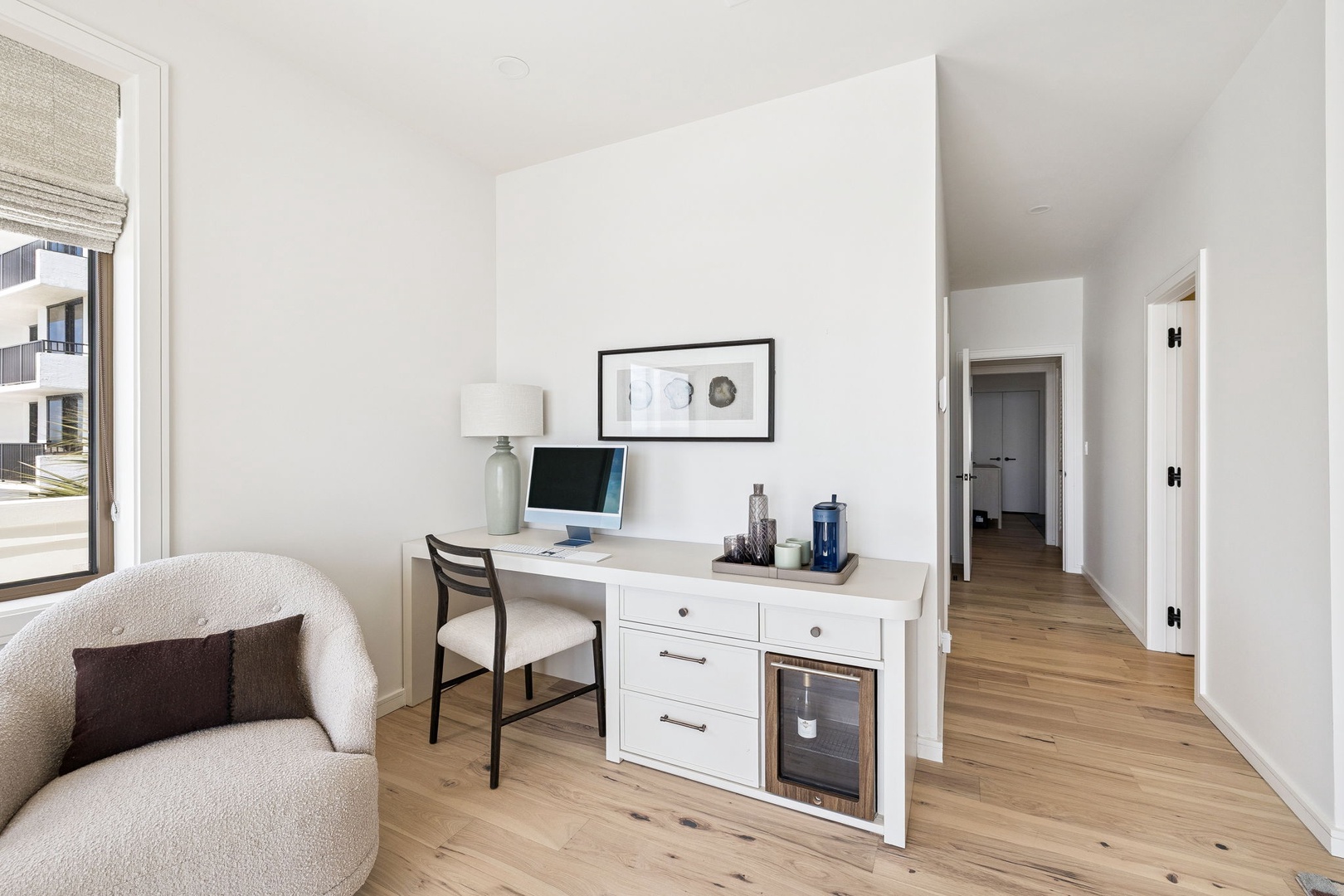 Settle into your dedicated workspace with built-in wine storage, where productivity meets relaxation in this thoughtfully designed corner.