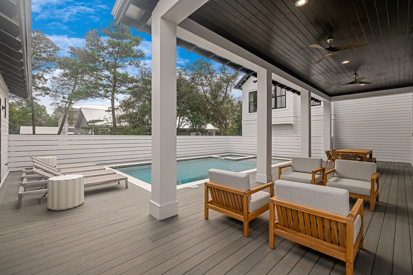 Your private covered terrace offers the perfect spot to unwind with comfortable seating overlooking your own sparkling pool.