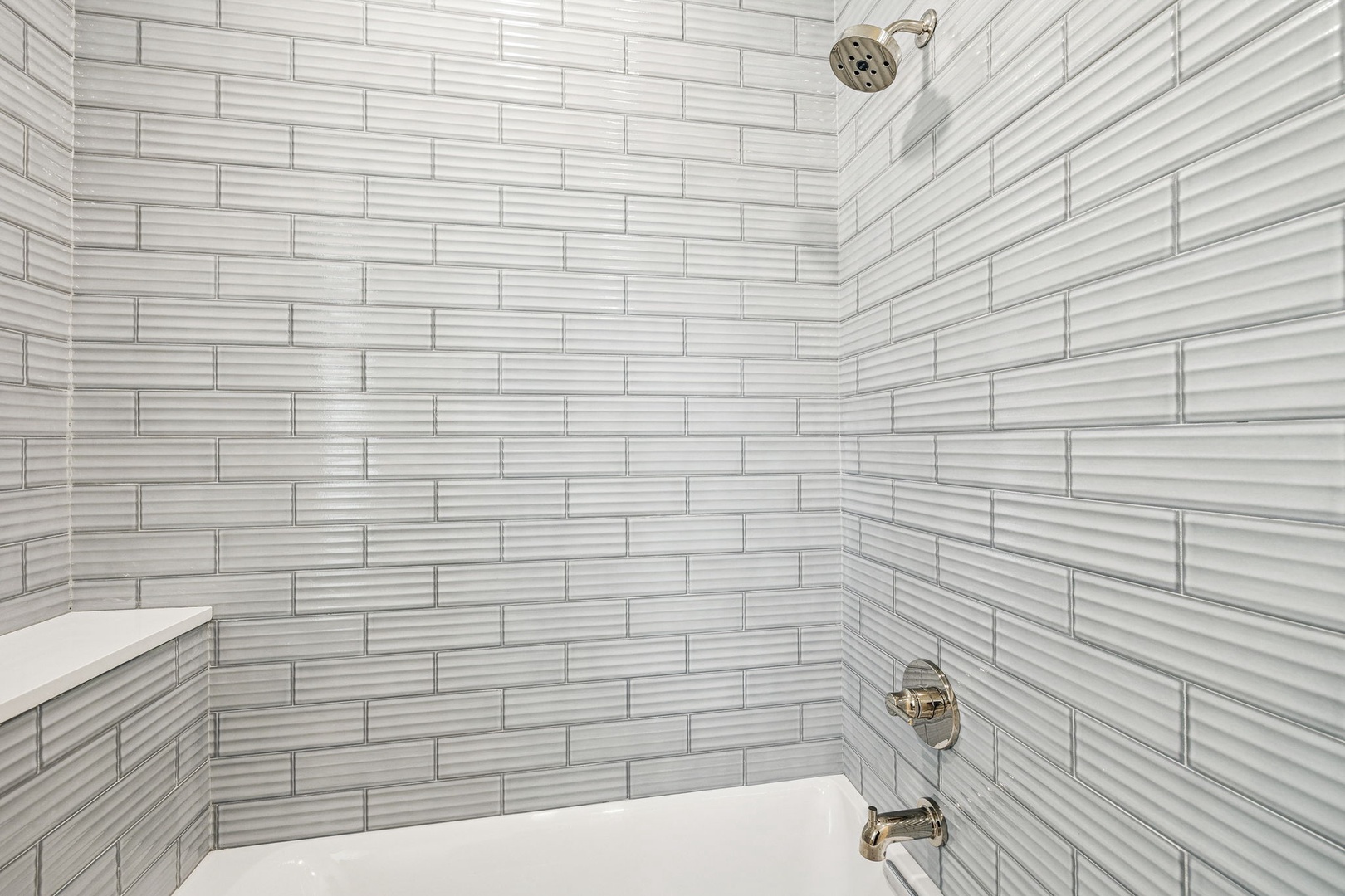 Step into your spa-like shower with gorgeous striped tile walls and modern fixtures for a luxurious bathing experience.