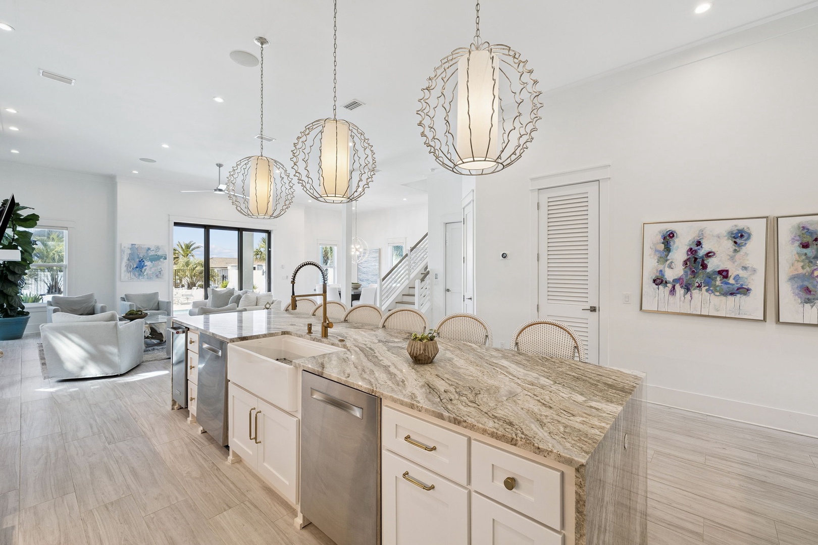 Gather around your stunning marble island where culinary adventures begin. This bright, open kitchen flows seamlessly into your living space.