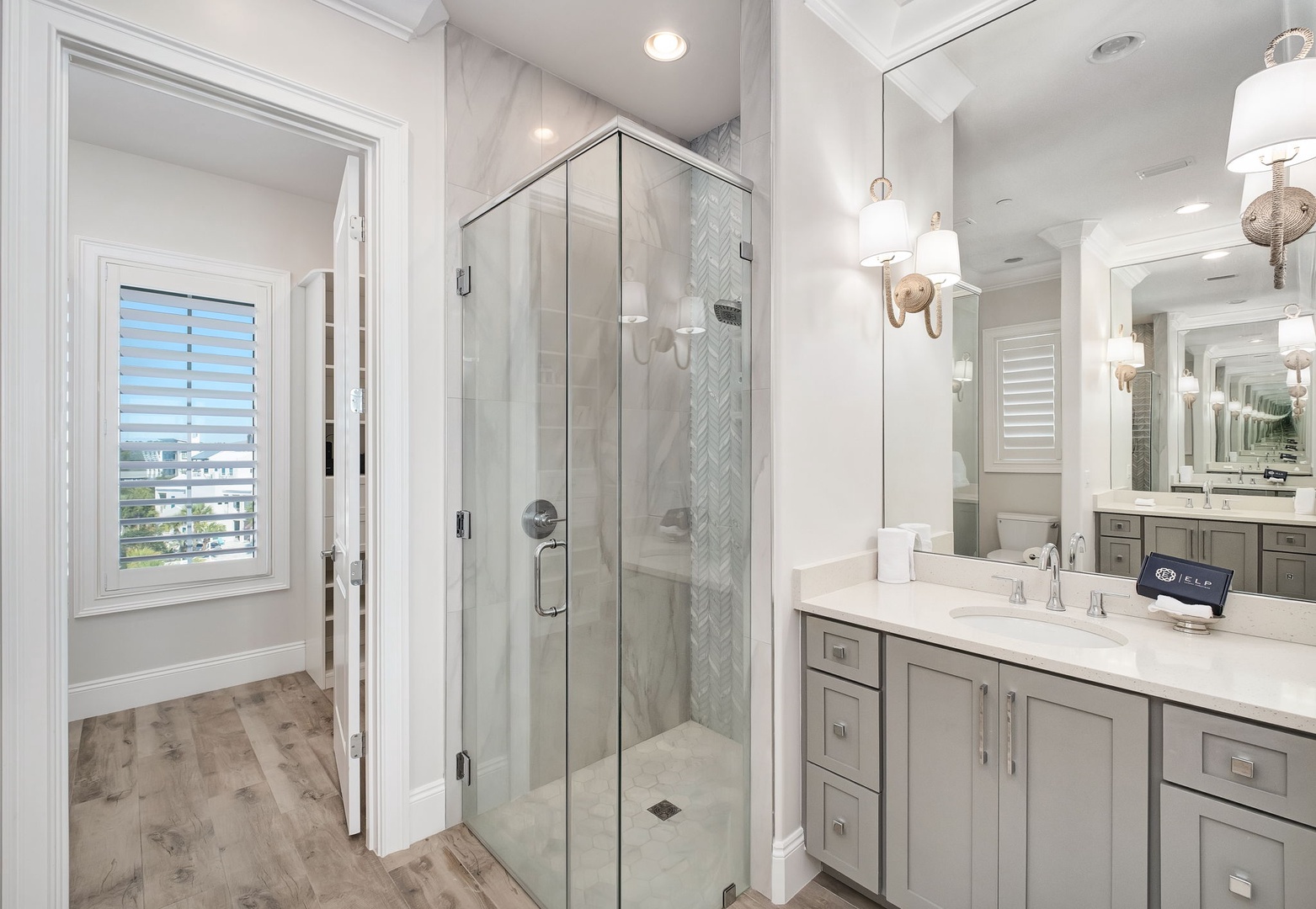 Your pristine marble bathroom features a luxurious walk-in shower and elegant dual vanities, creating a spa-like retreat for your daily routine.