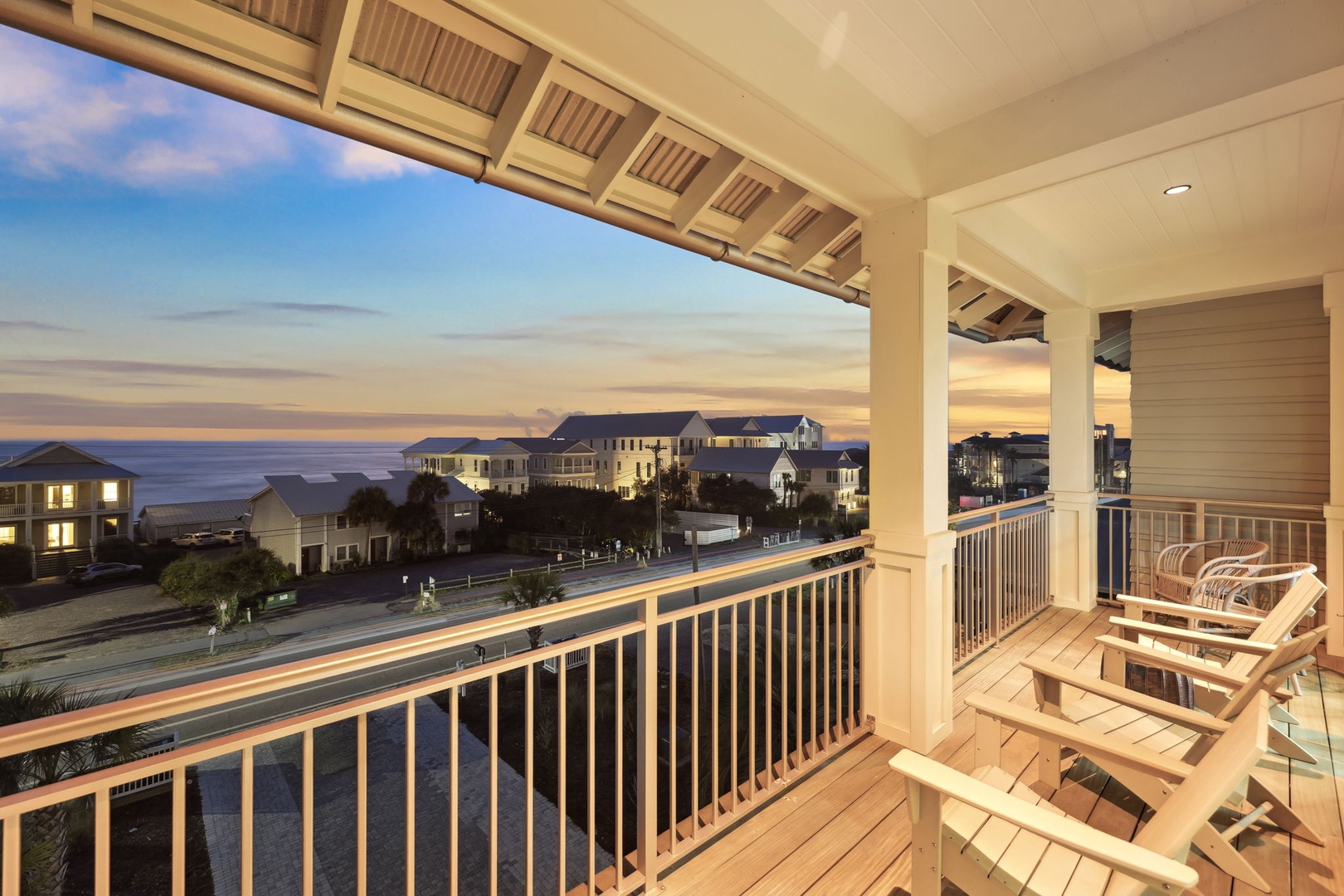 Sip your morning coffee on this covered balcony while watching the sunrise paint the sky in golden hues over the ocean and coastal homes.