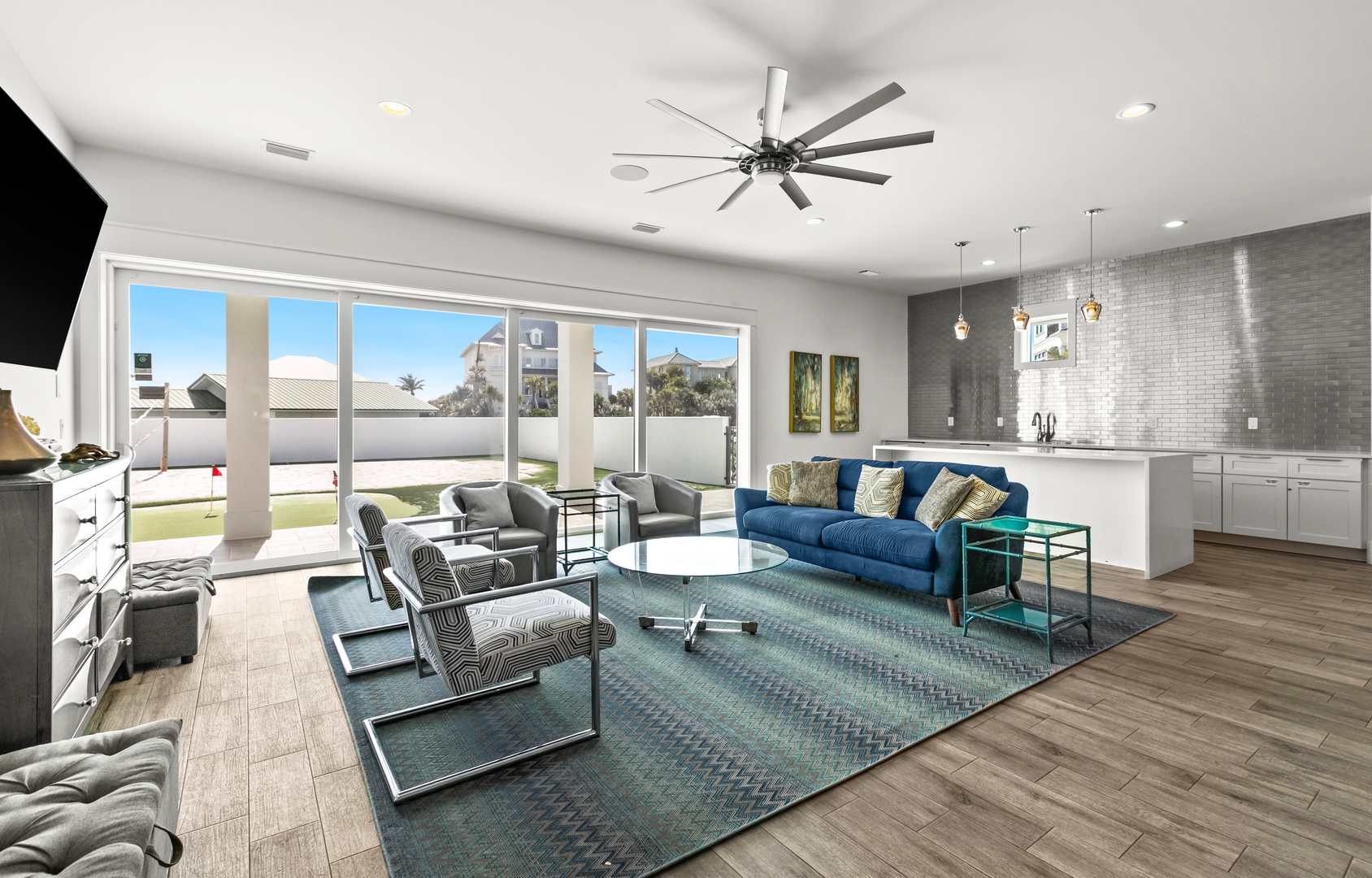 Sink into plush seating and enjoy your private outdoor oasis through floor-to-ceiling glass doors, with modern style and an open layout perfect for relaxing or entertaining.