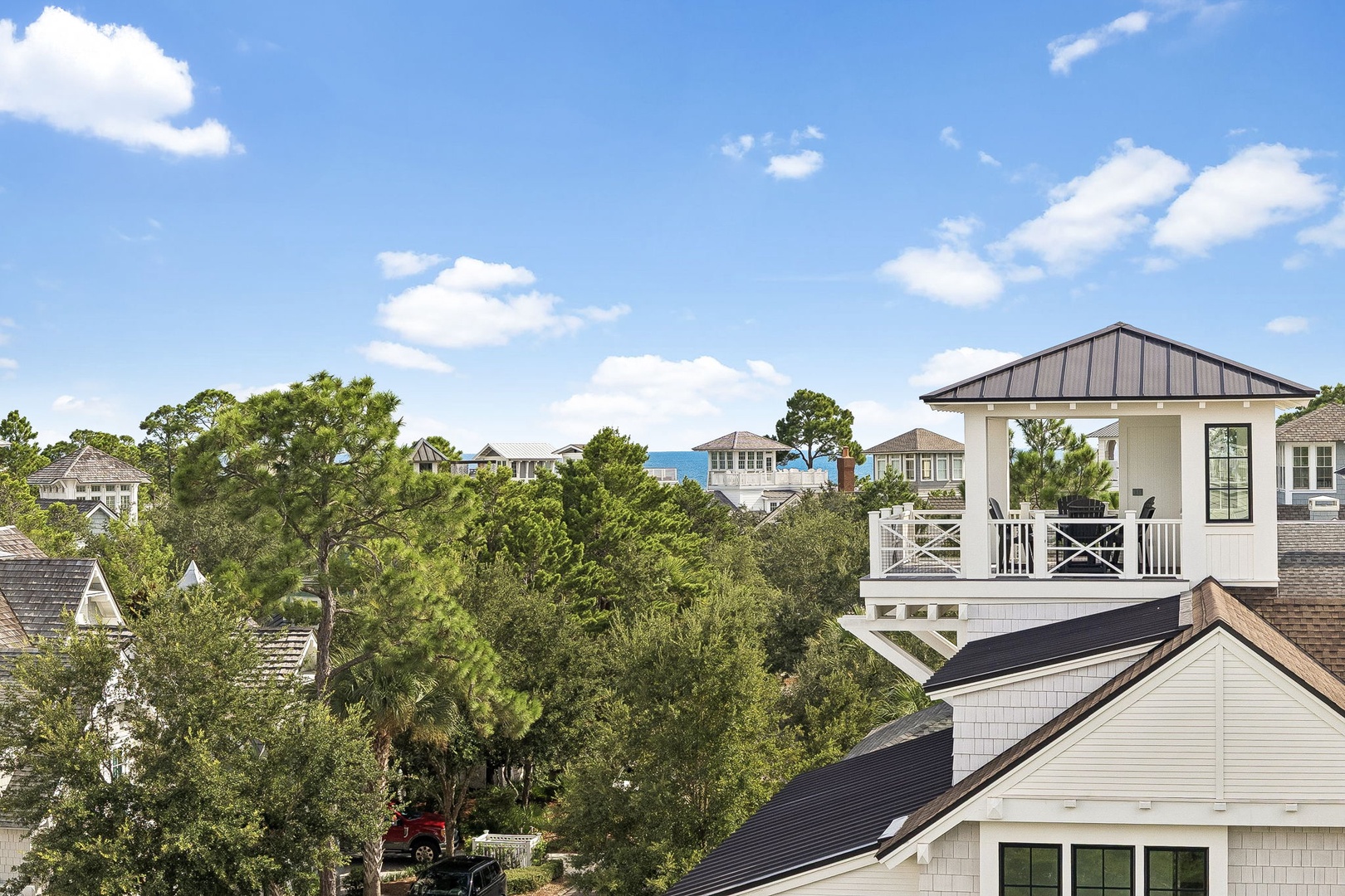 The property sits in a quiet coastal neighborhood with lush greenery, offering a peaceful retreat near the beach and nearby attractions.