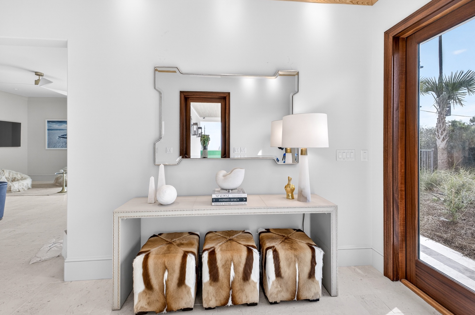 Your elegant entryway welcomes you with refined touches and warm natural light streaming through expansive windows.