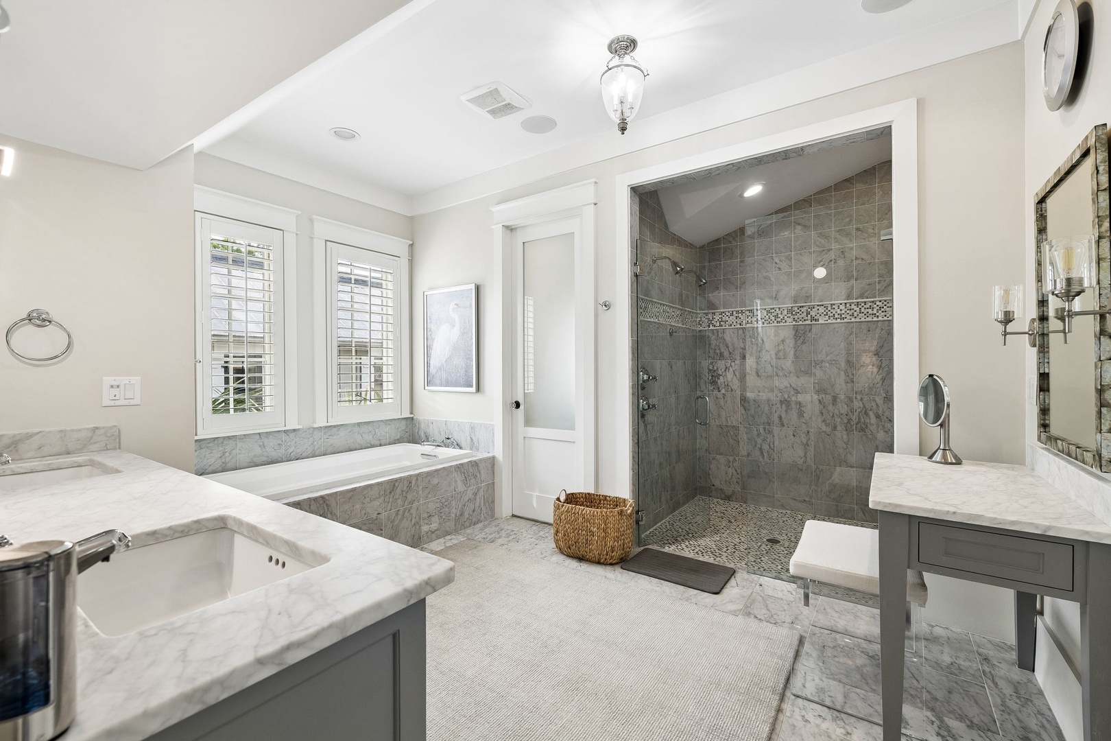 Indulge in your private spa-like retreat with a deep soaking tub, spacious walk-in shower with dual controls, and elegant marble finishes throughout. Natural light and refined touches create a serene escape for relaxation.