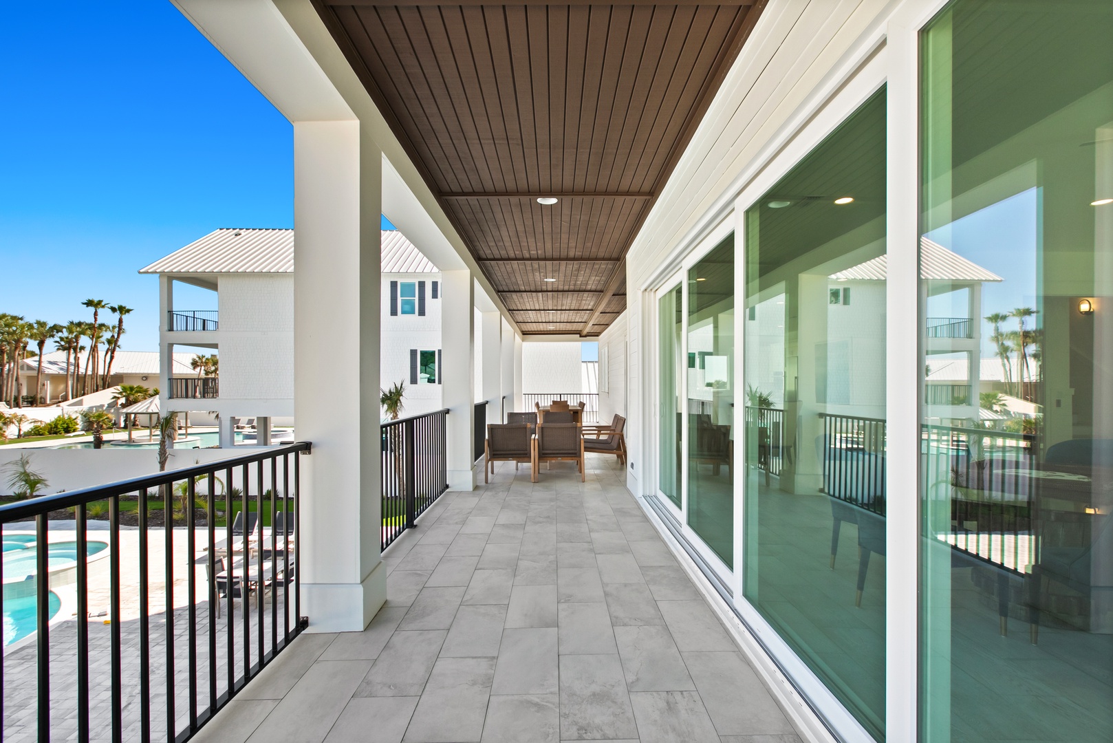 Step onto your private covered balcony and take in the bright coastal air. With poolside views and seating just steps from your door, you'll find your perfect spot to relax and unwind.