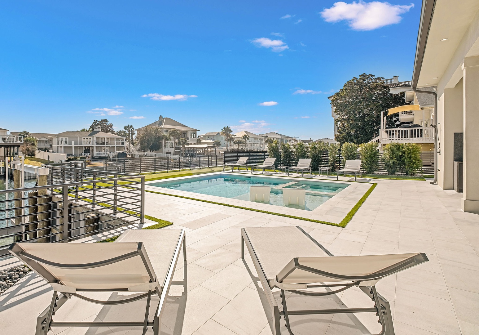 Relax in your modern poolside lounge chairs while soaking up the sun on this expansive private terrace with sparkling pool.