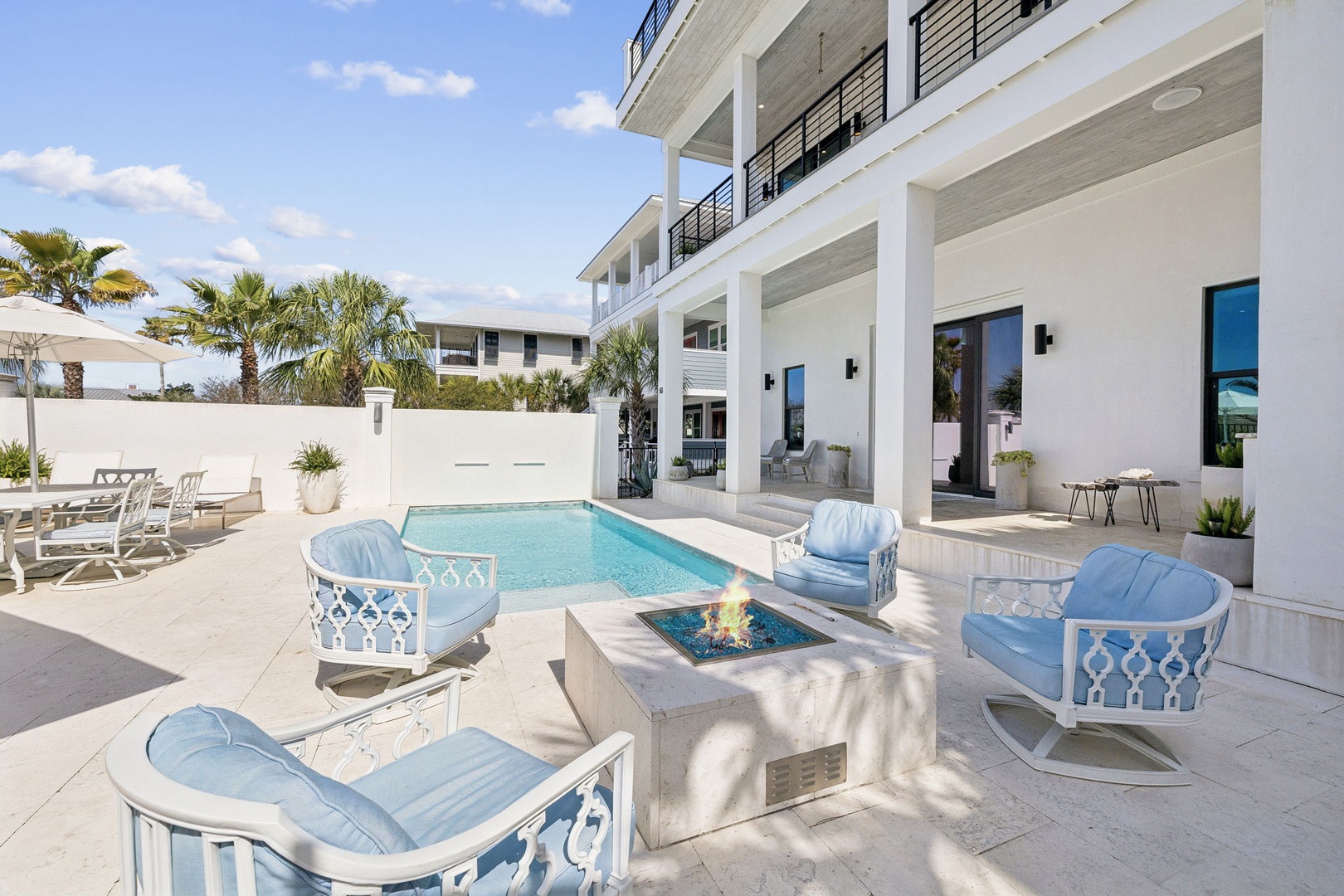 Your private oasis awaits with sparkling pool, cozy fire pit seating, and elegant covered terrace perfect for sunset cocktails.