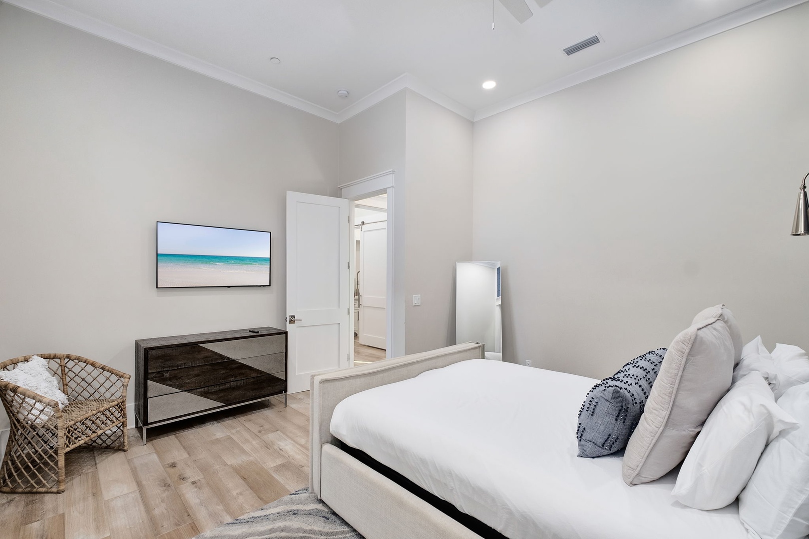 Drift off to sleep in your serene coastal-themed bedroom, complete with smart TV entertainment and peaceful ocean artwork.