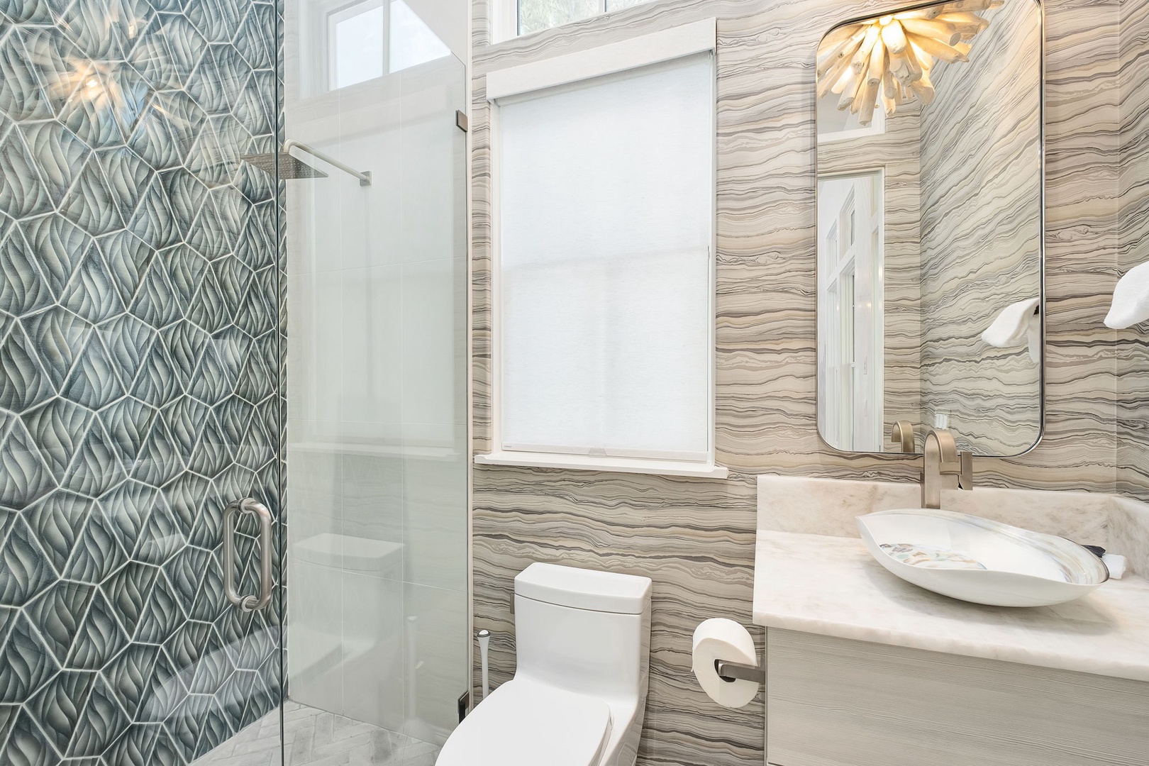 A serene modern bathroom awaits, where natural textures blend with sleek fixtures to create your perfect retreat after a day of exploration.