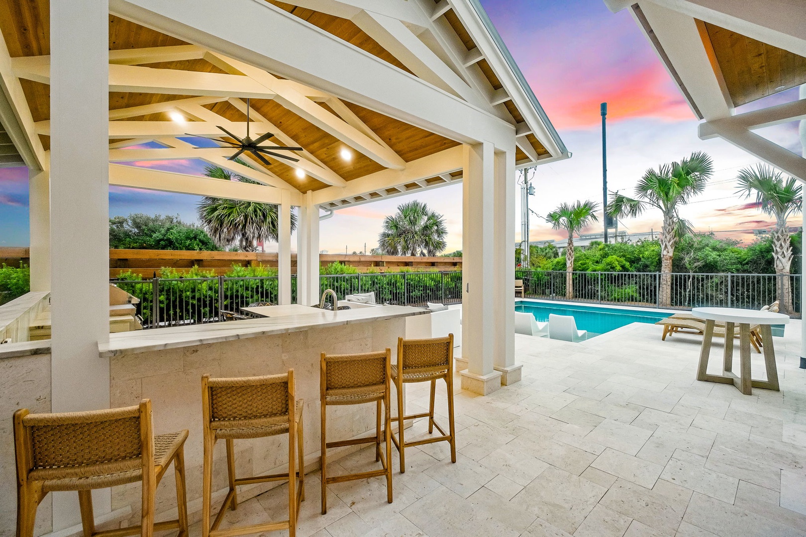 Sip your morning coffee at the outdoor bar while soaking in stunning sunset hues over the pool and tropical palms—your private oasis awaits.